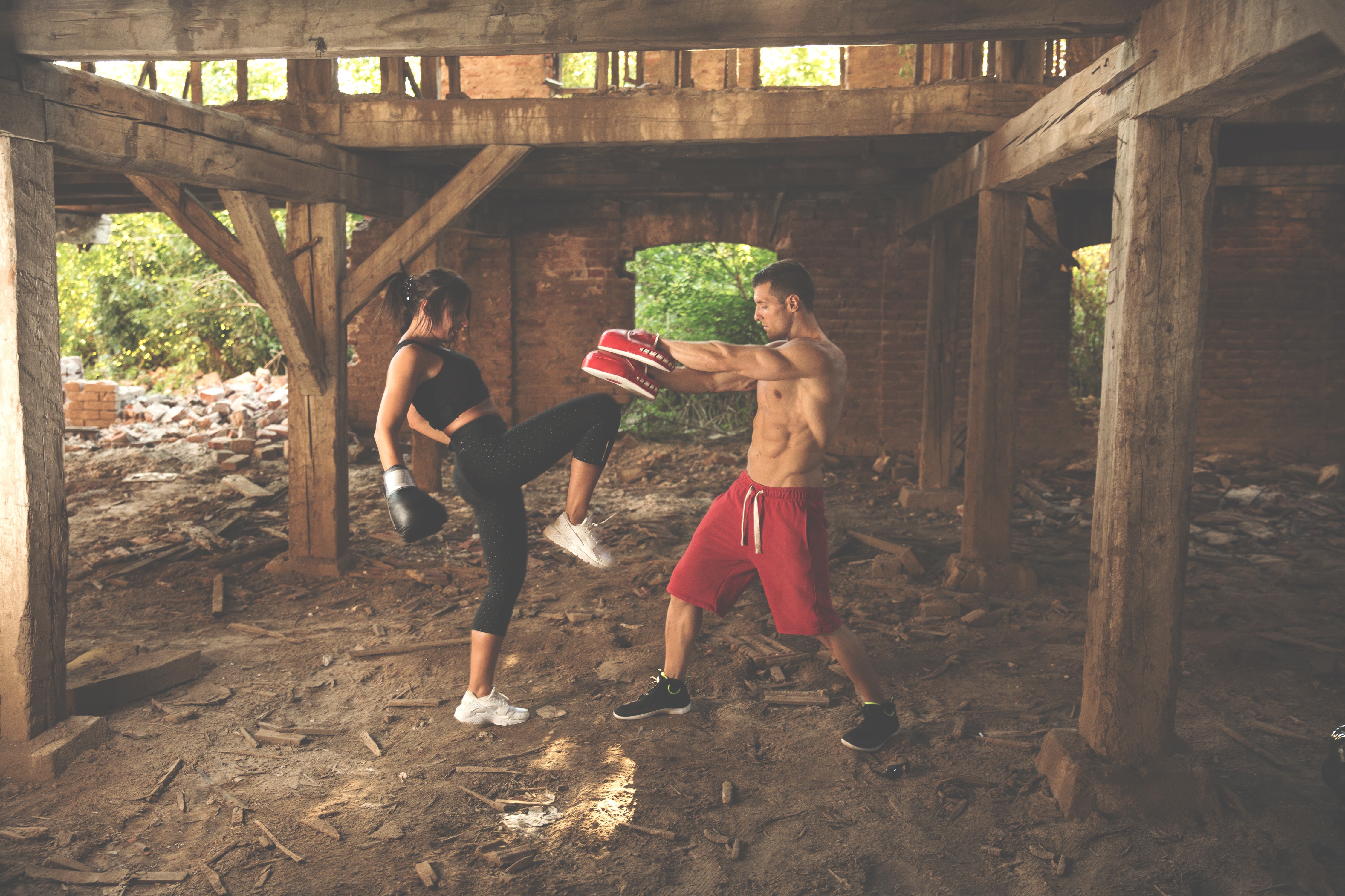 Man and woman boxing training in abandoned building HD Wallpaper