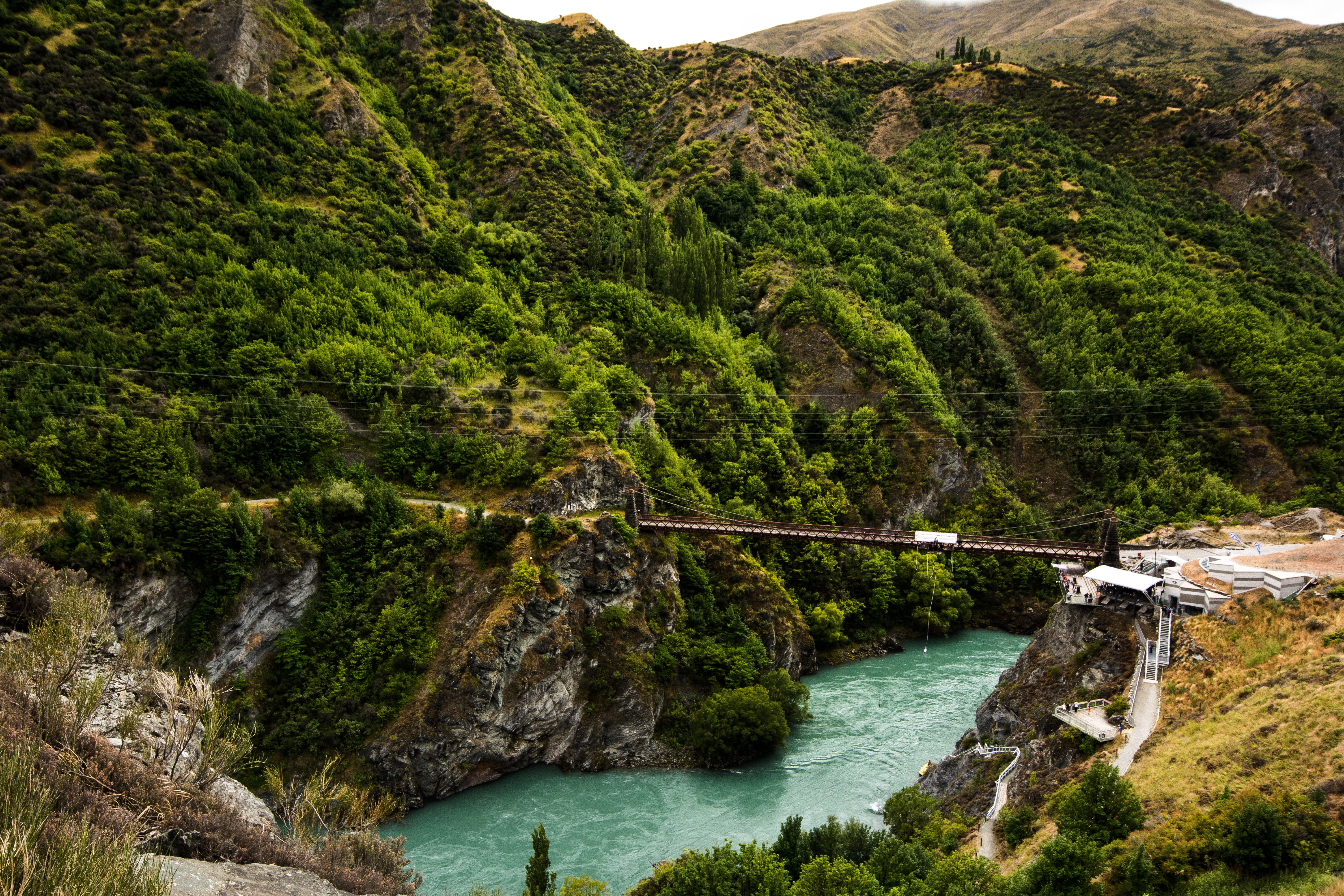 Bridge over turquoise river in Queenstown, New Zealand HD Wallpaper