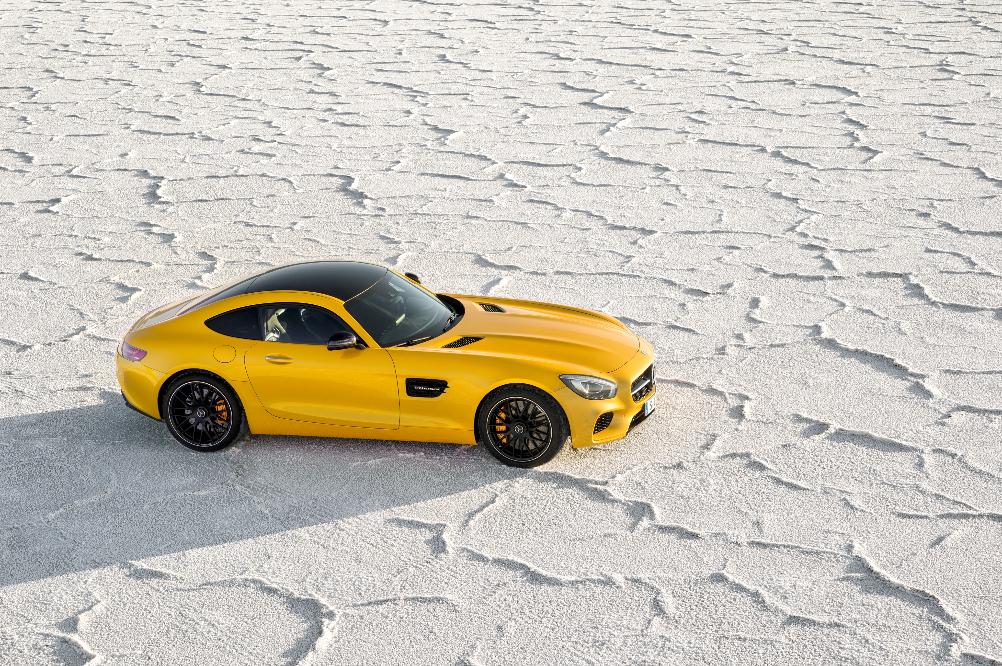 Yellow Mercedes-Benz AMG GT S on salt flats HD Wallpaper