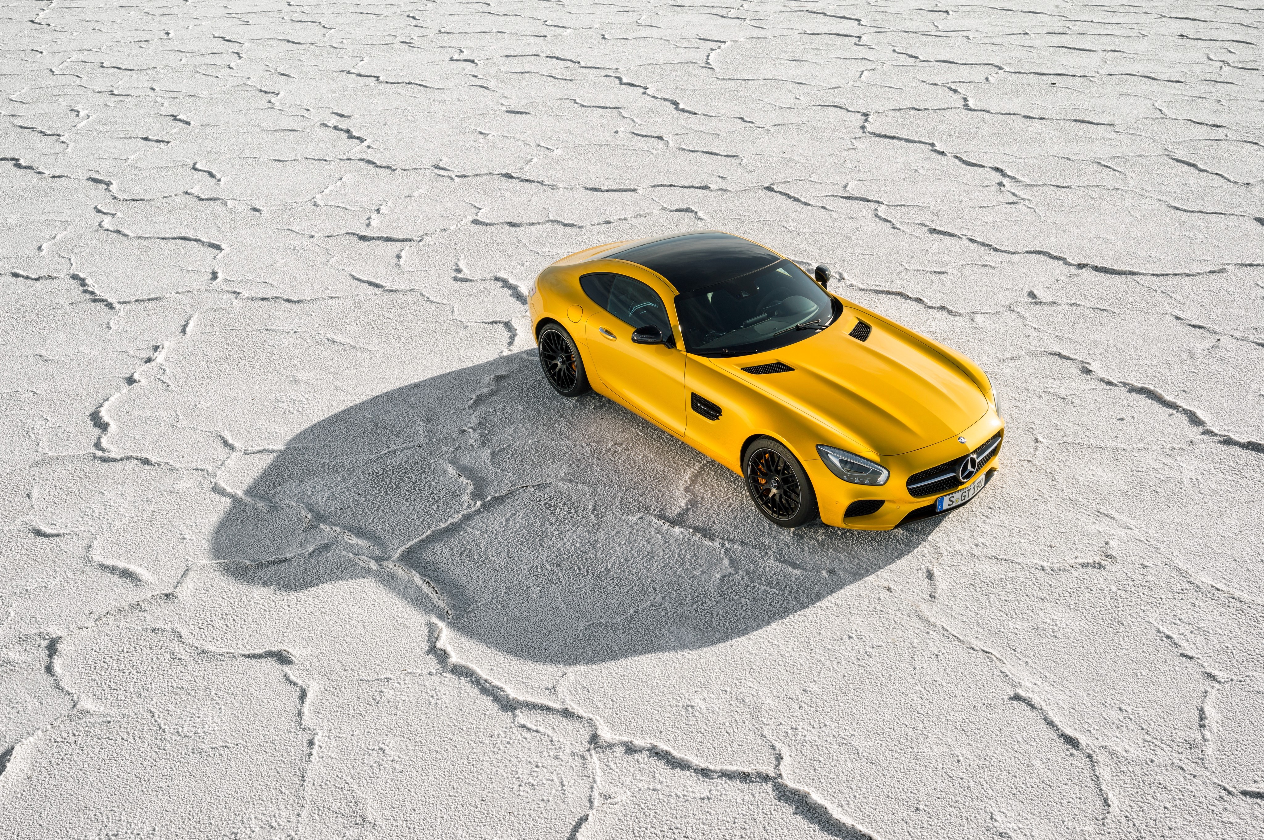 Yellow Mercedes-Benz AMG GT S on salt flats HD Wallpaper