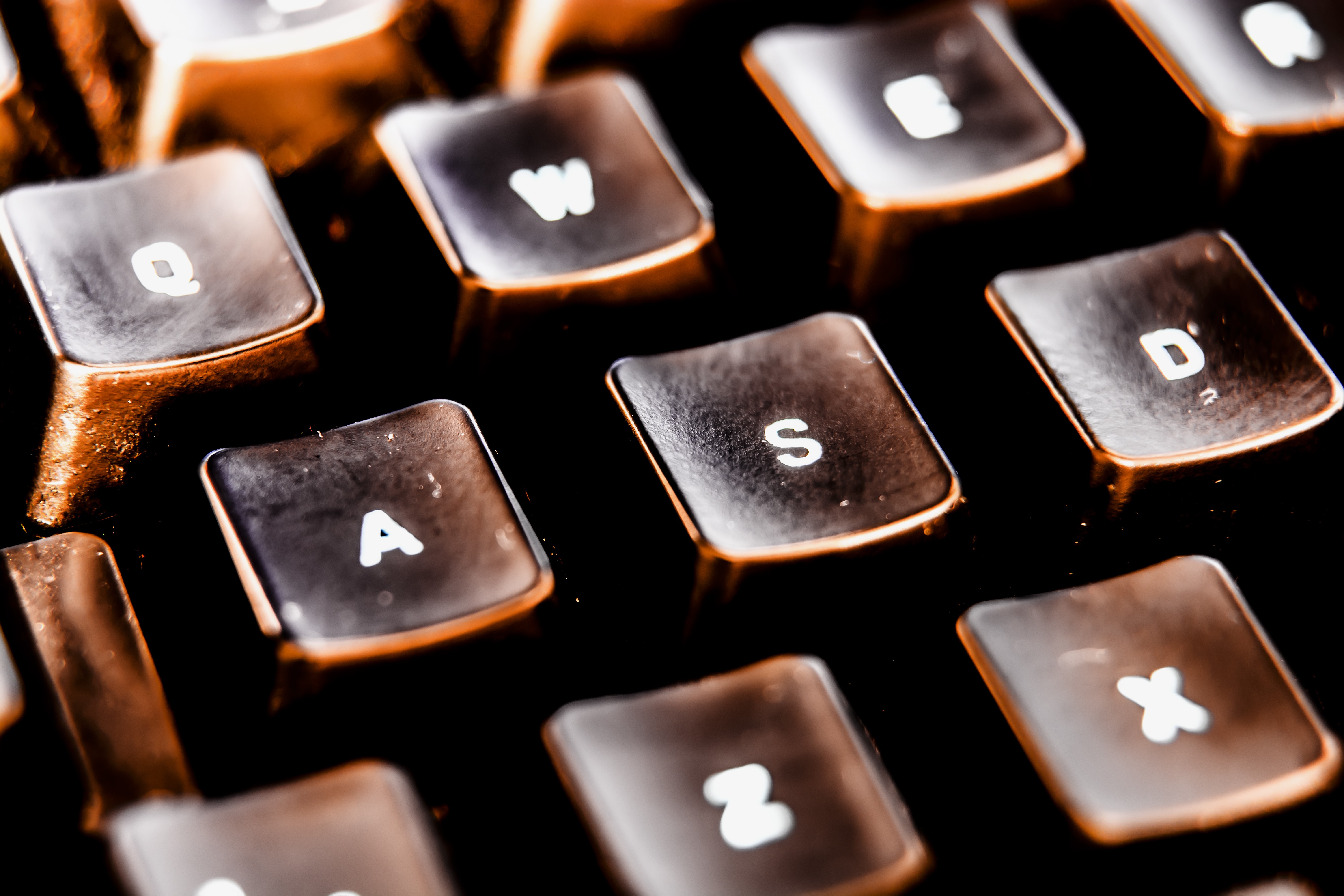 Macro closeup of a retro keyboard with orange lighting HD Wallpaper
