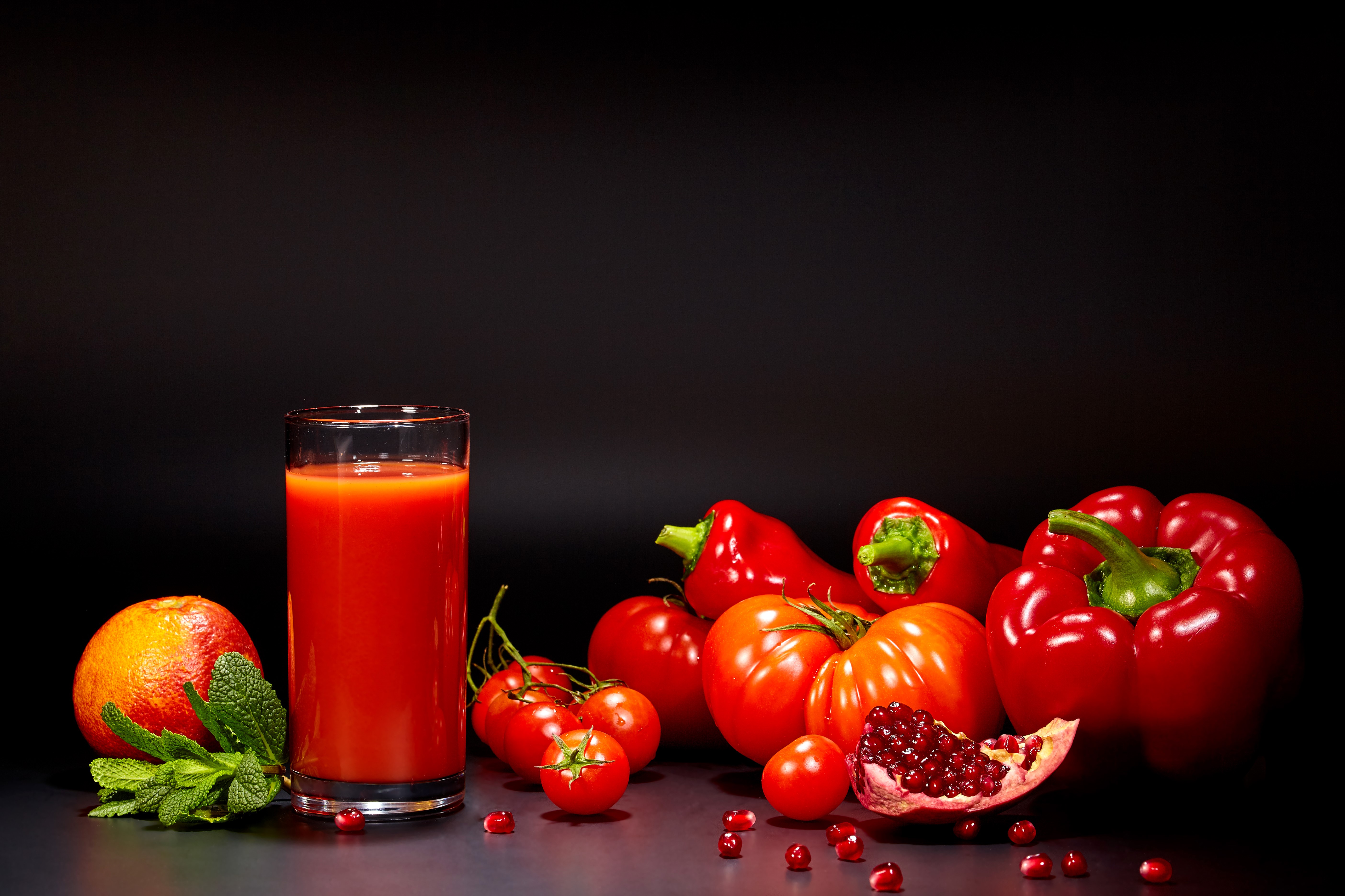 Juice, Tomatoes, Bell Pepper, Pomegranate, and Orange on Black Background HD Wallpaper