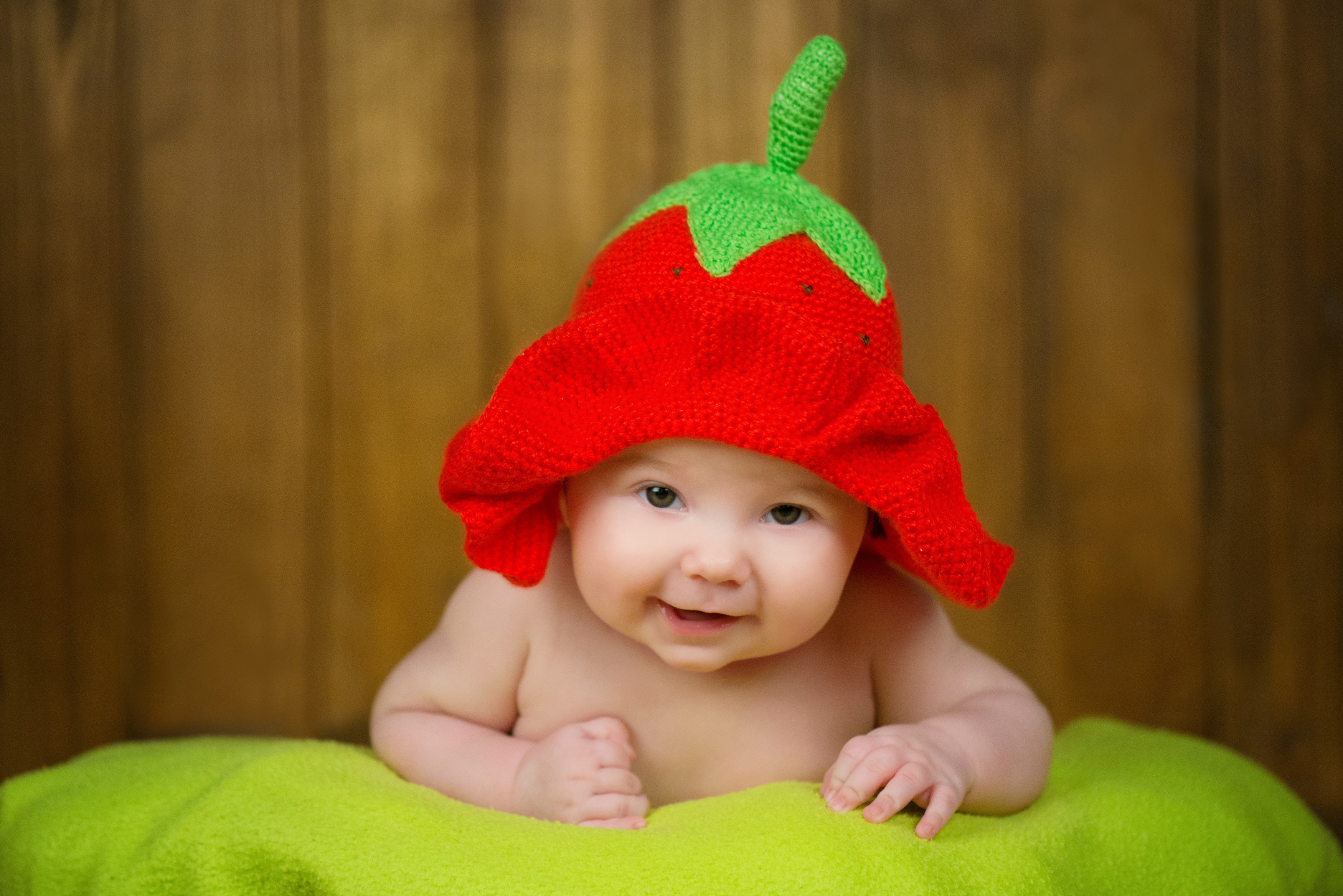 Baby wearing a strawberry hat HD Wallpaper