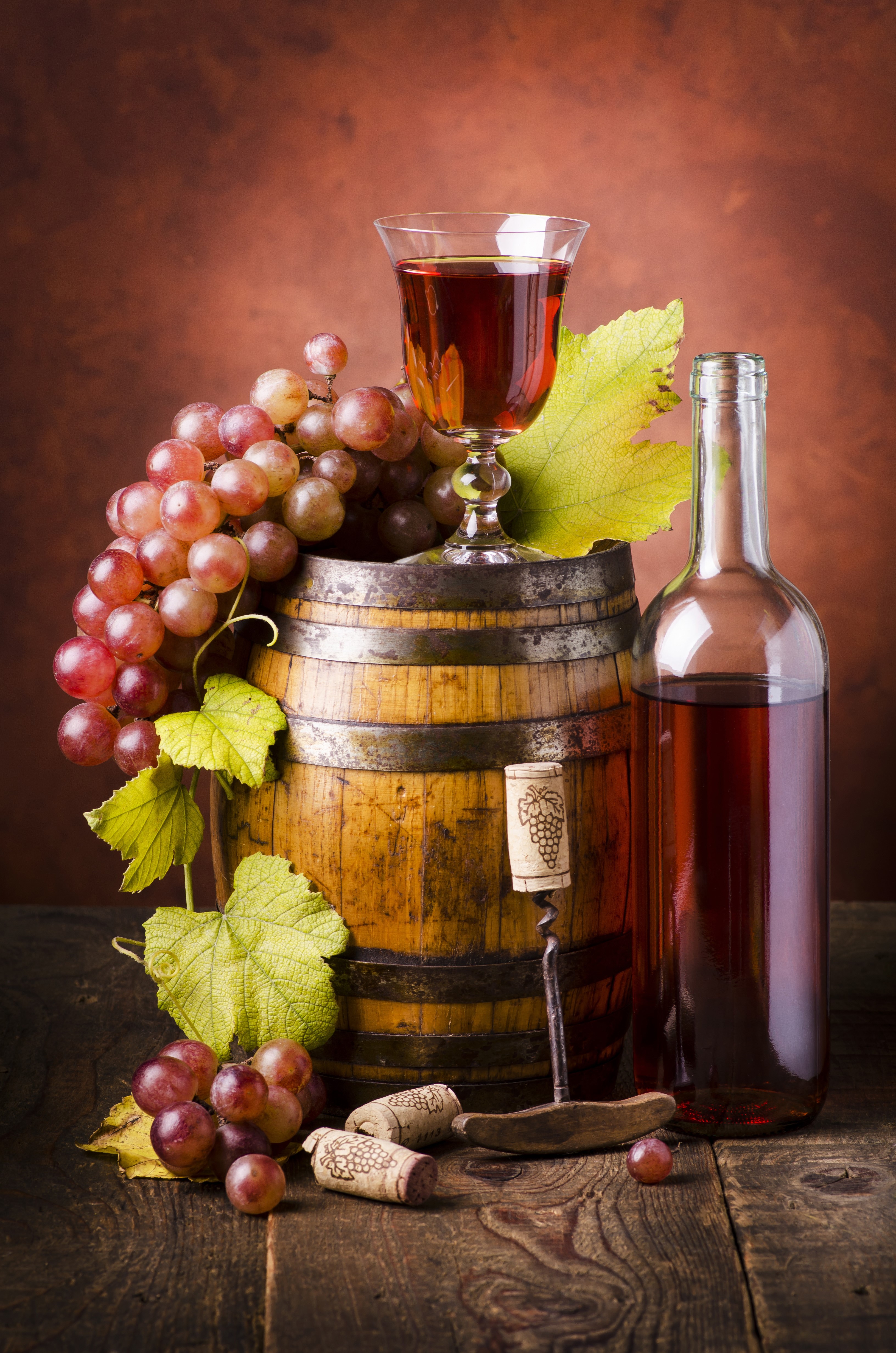 Wine bottle, glass, barrel, and grapes on wood HD Phone Wallpaper