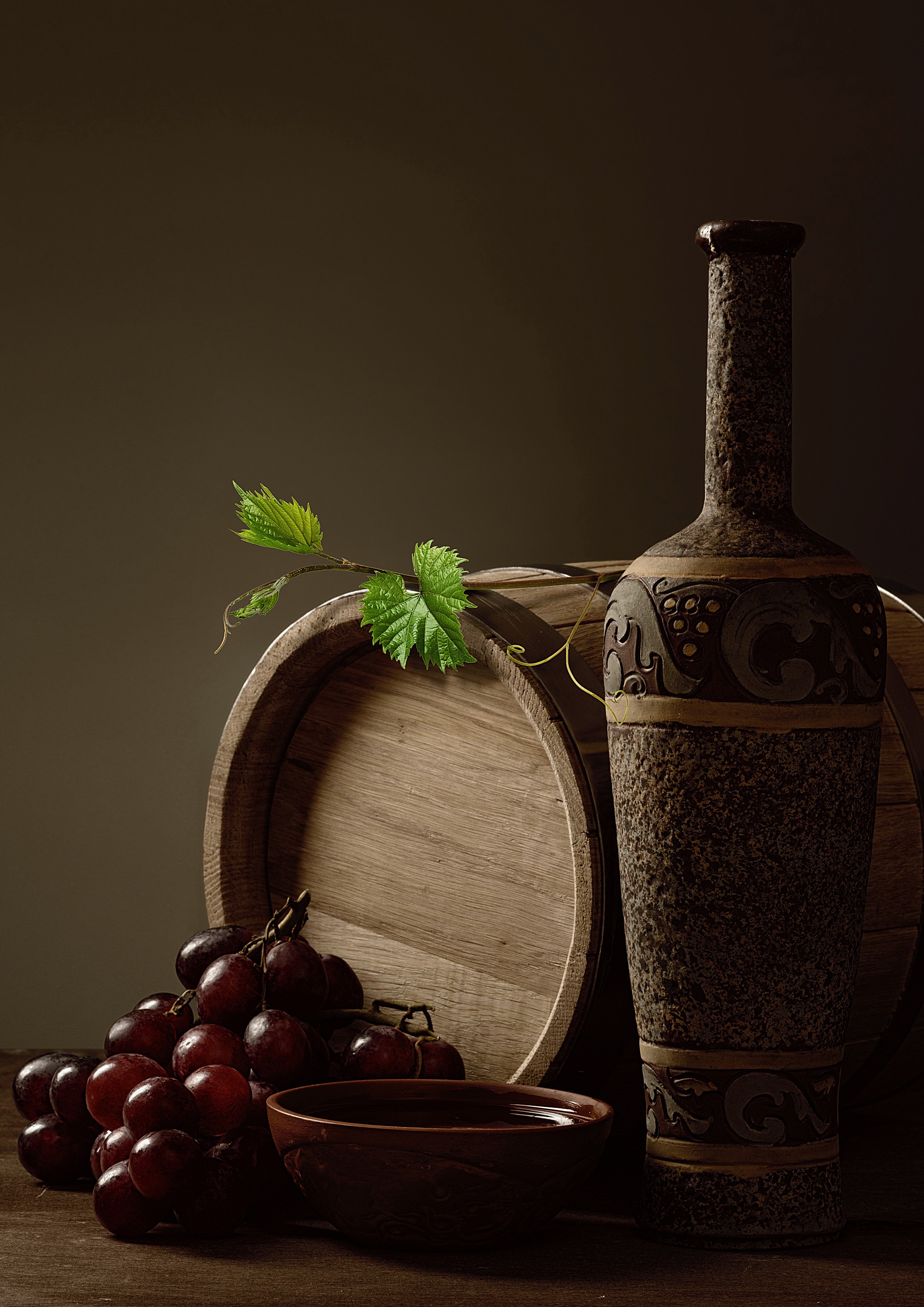 Still life with wine bottle, grapes, and barrel HD Phone Wallpaper