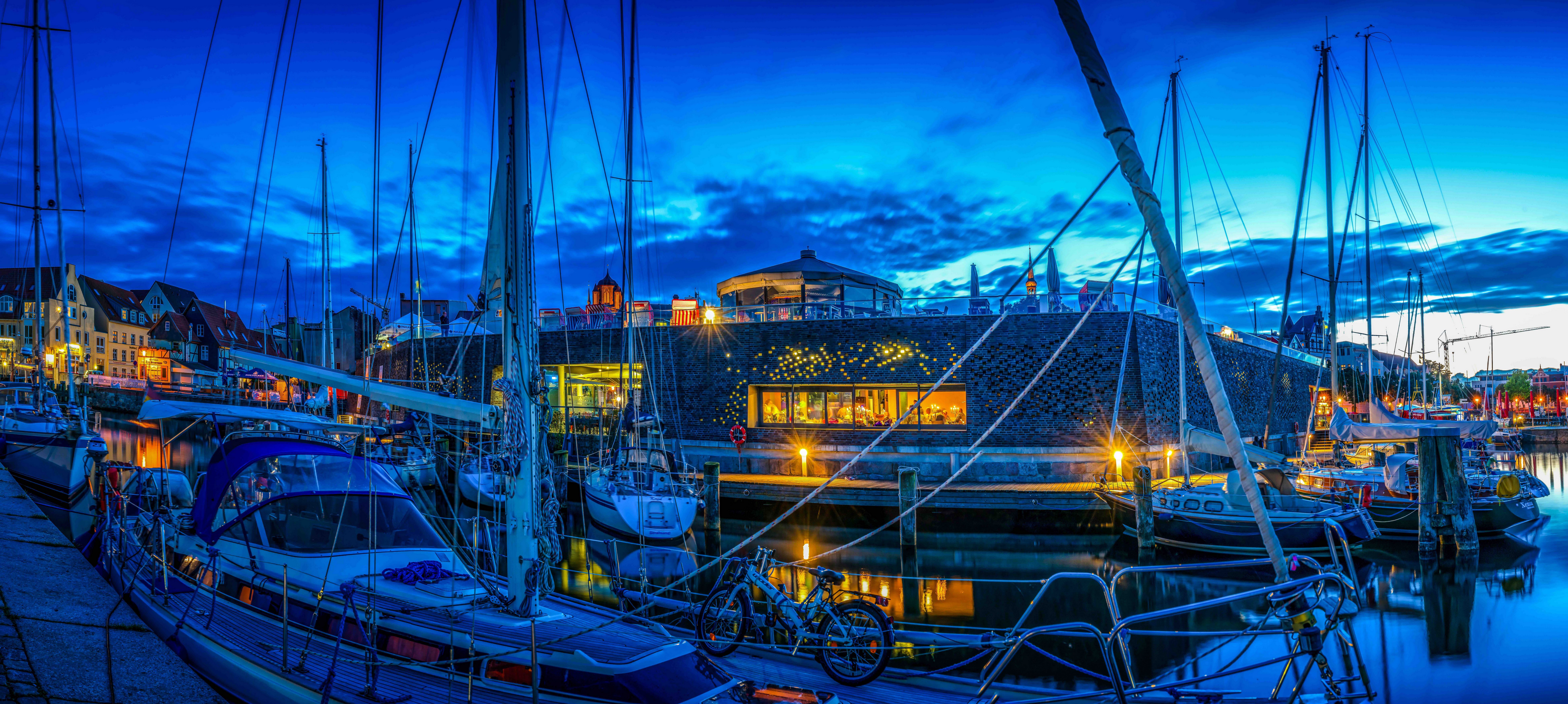 Boats docked in a marina at dusk in Stralsund, Germany HD Wallpaper