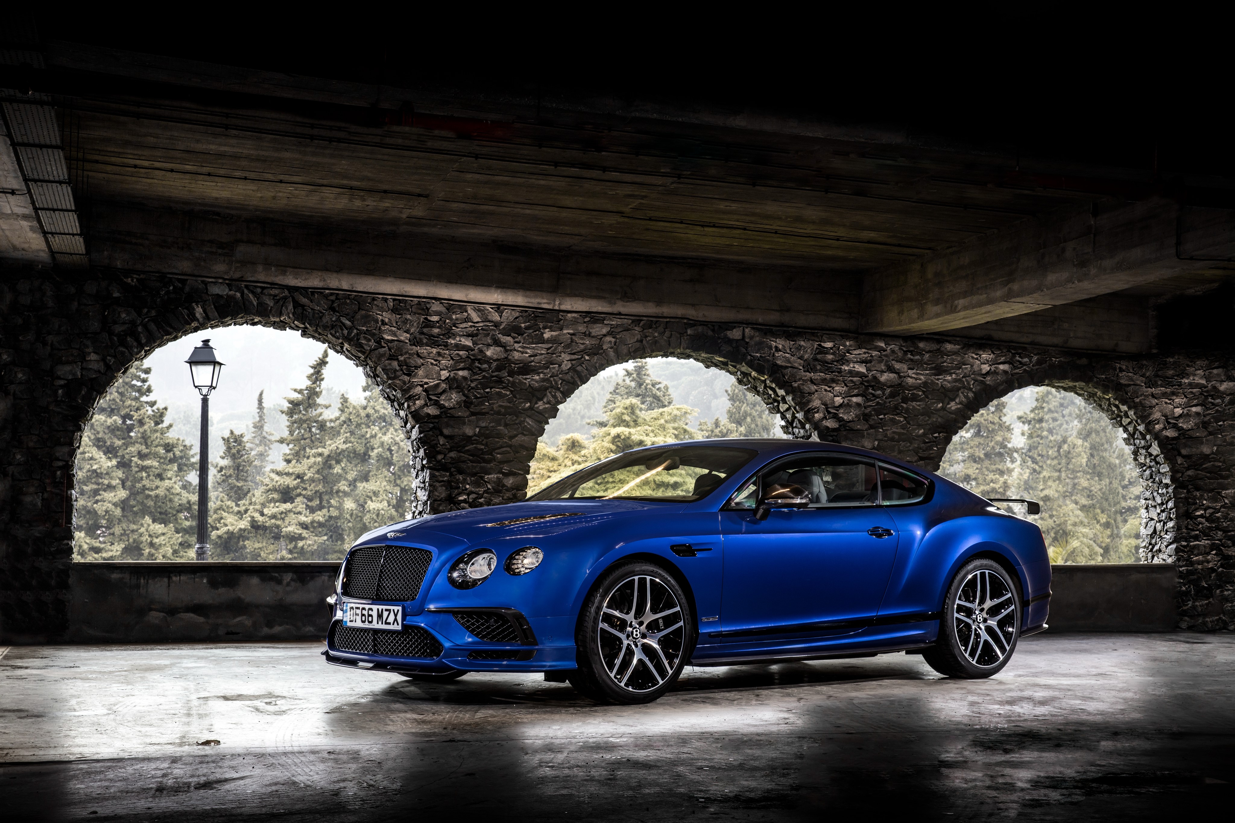 Blue Bentley Continental Supersports parked under stone arches HD Wallpaper