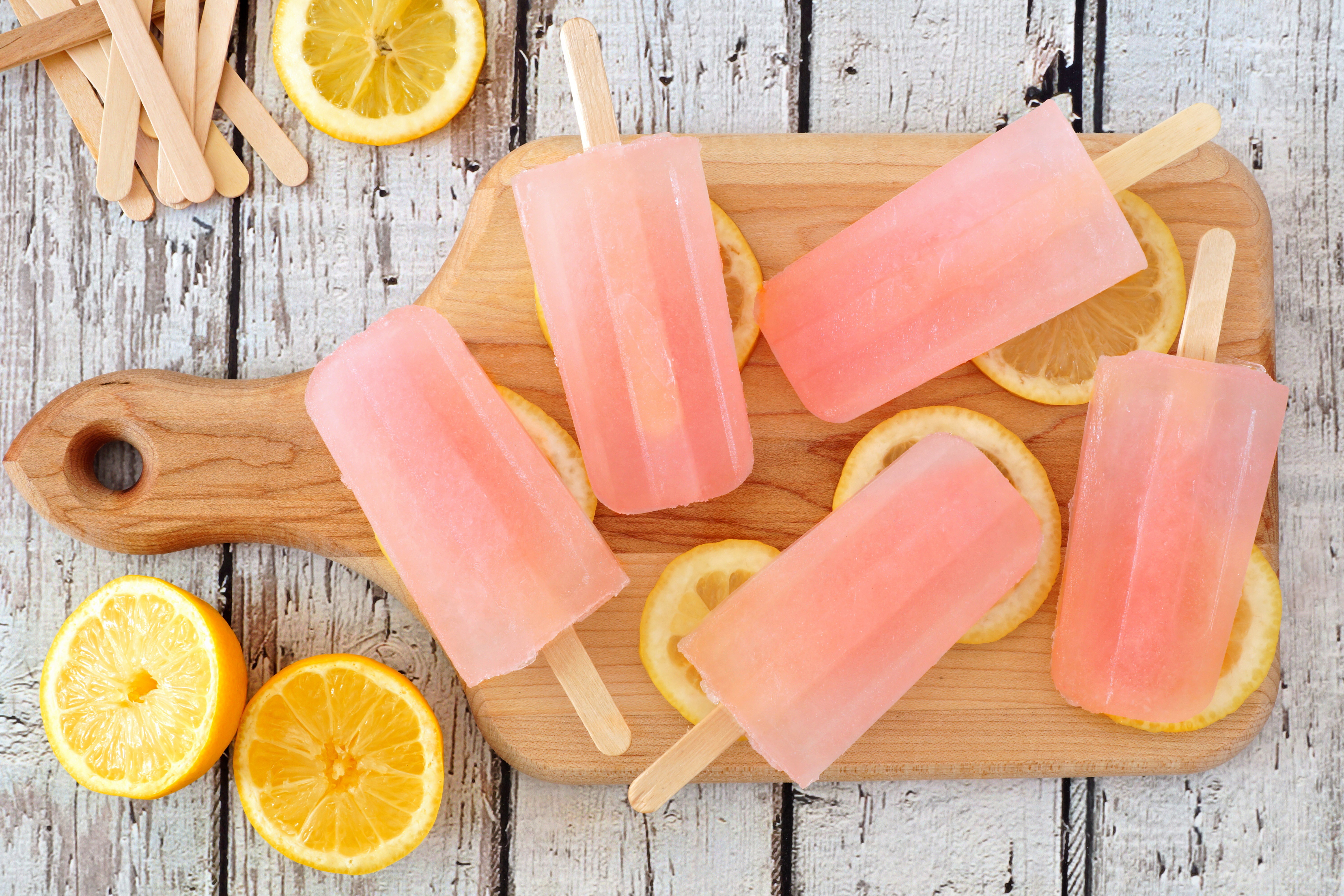 Pink popsicles with lemons on a cutting board HD Wallpaper