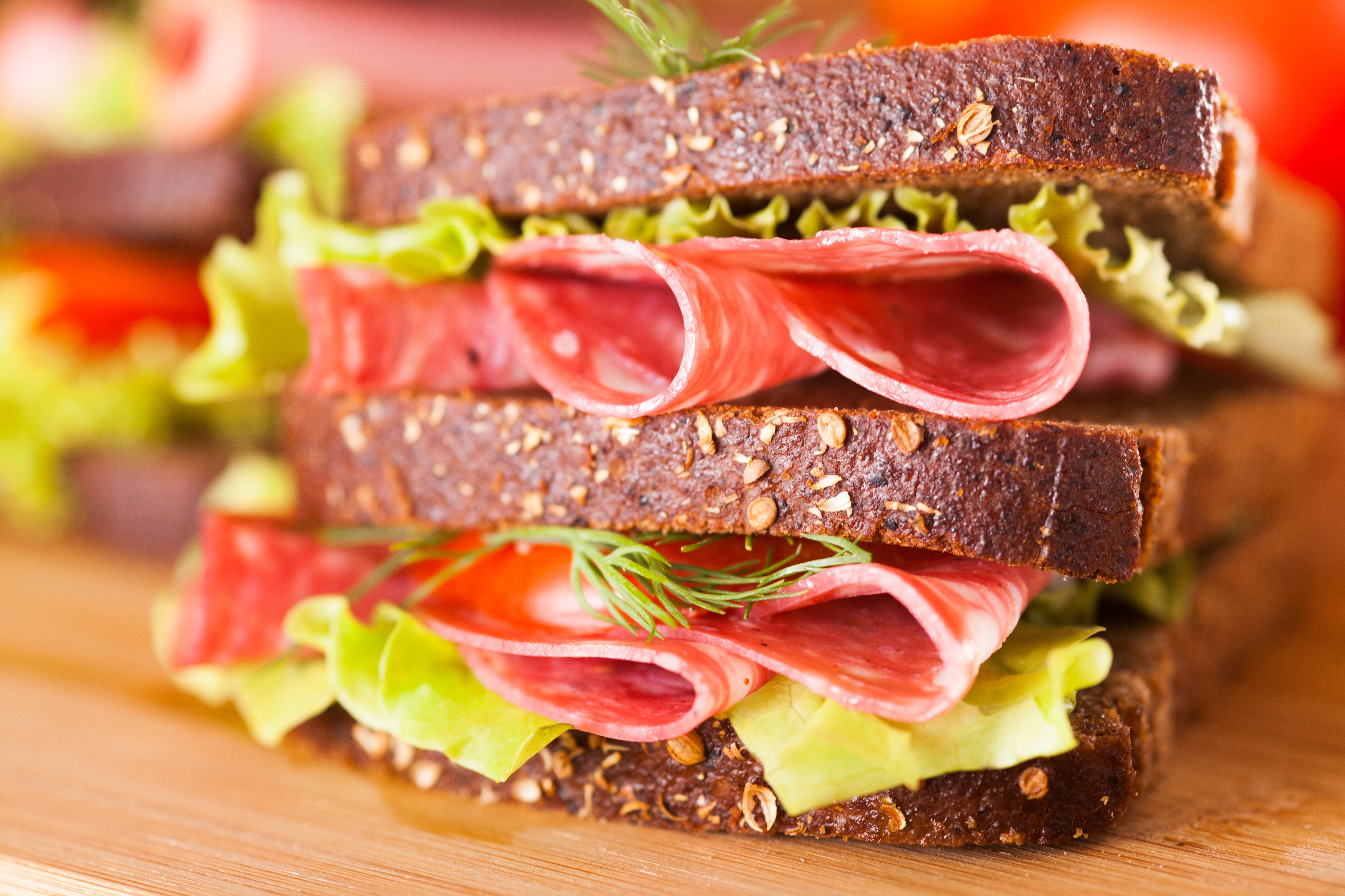 Sandwich with salami, lettuce, and dill on dark bread HD Wallpaper