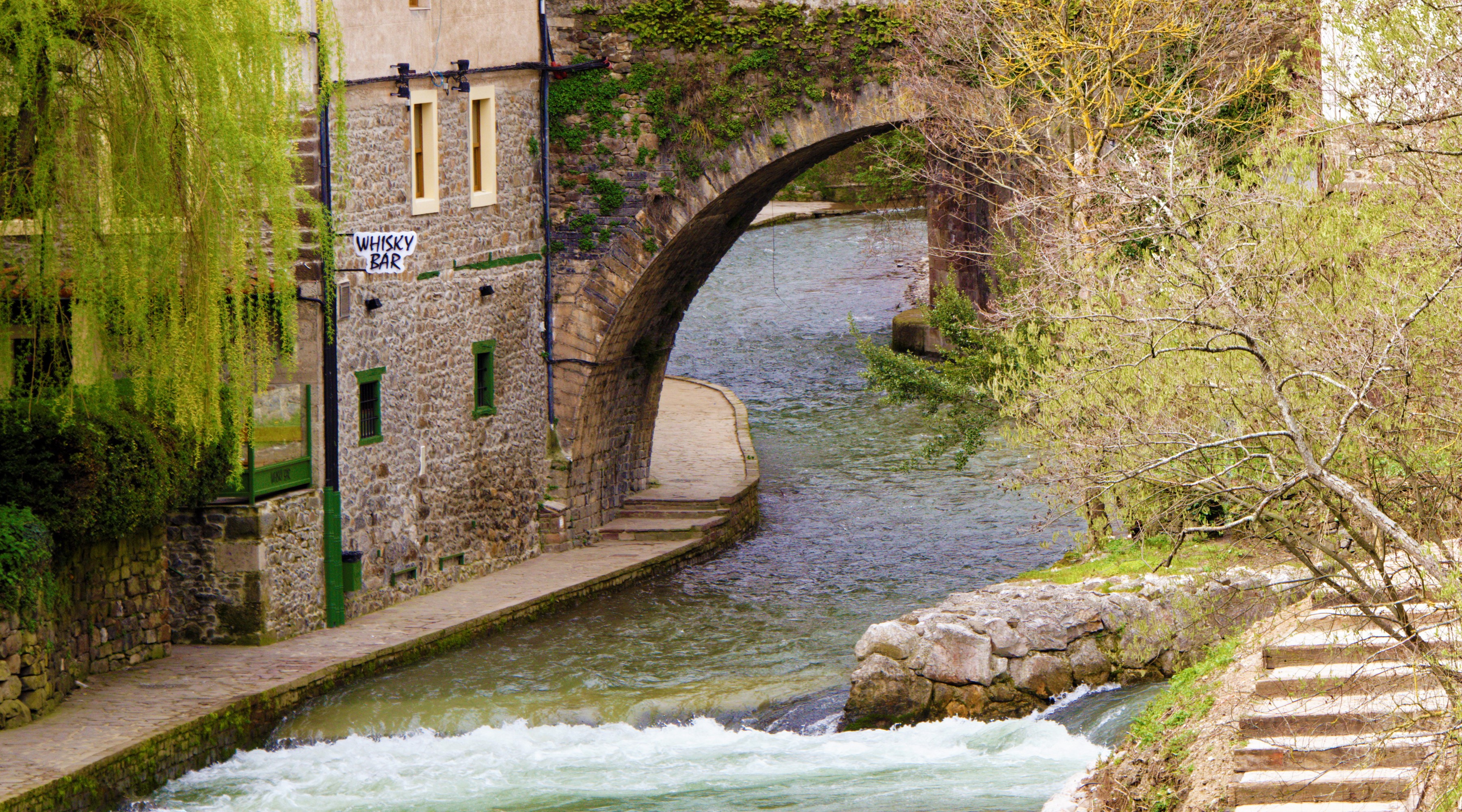Stone bridge over a river in Potes, Cantabria, Spain HD Wallpaper