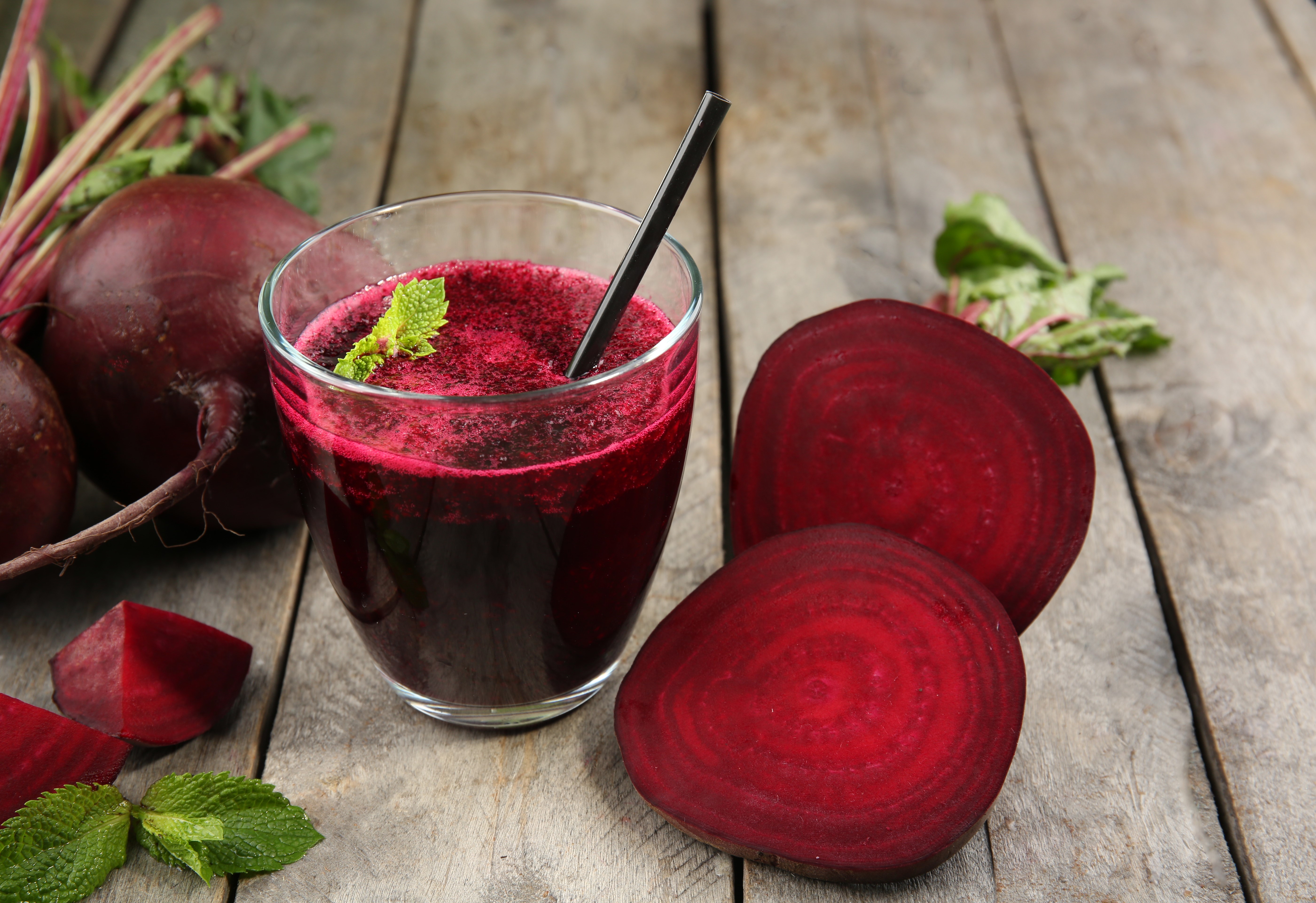 Beetroot juice in a glass with beets on wood planks HD Wallpaper