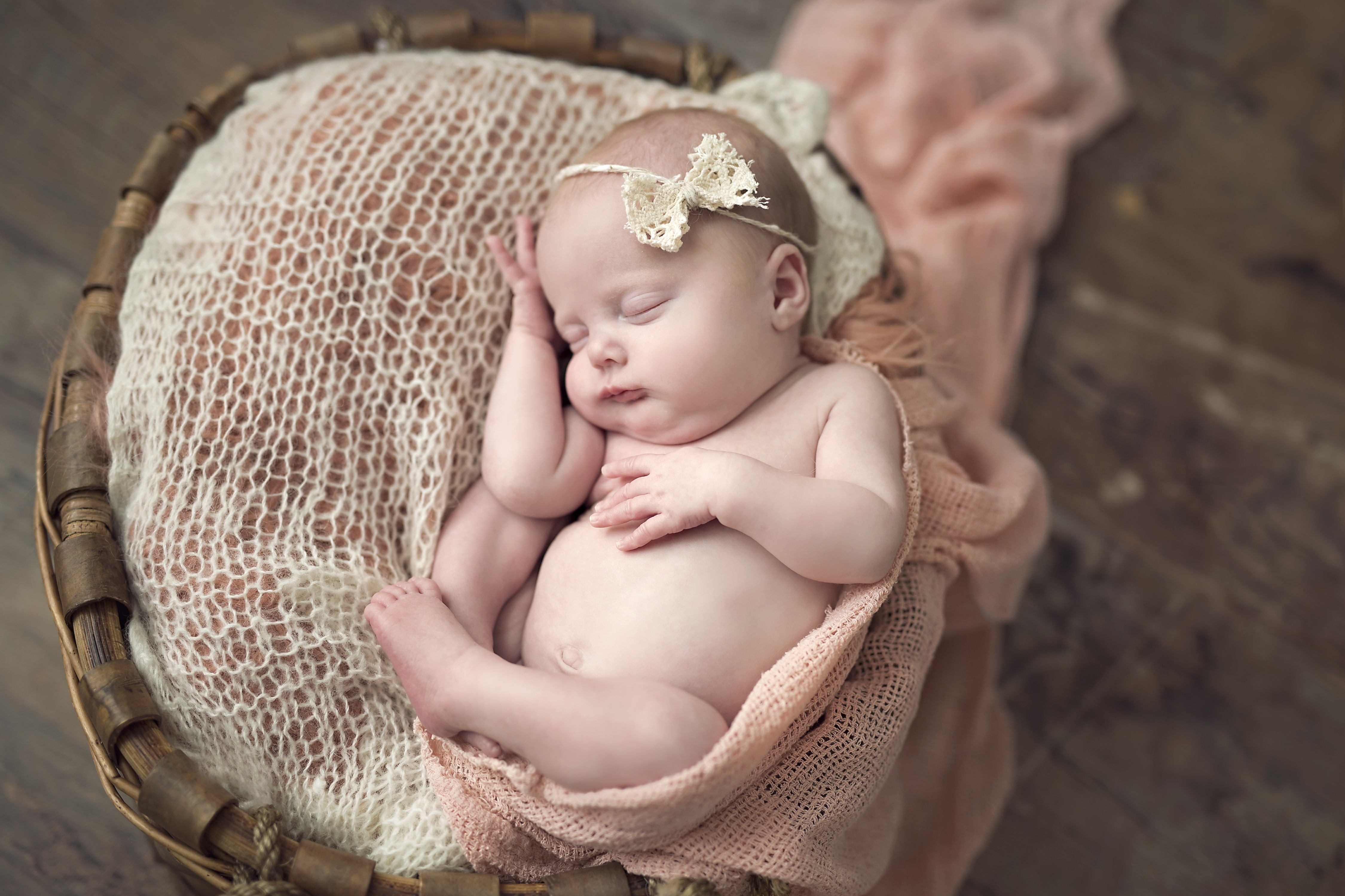 Newborn baby sleeping in a basket HD Wallpaper