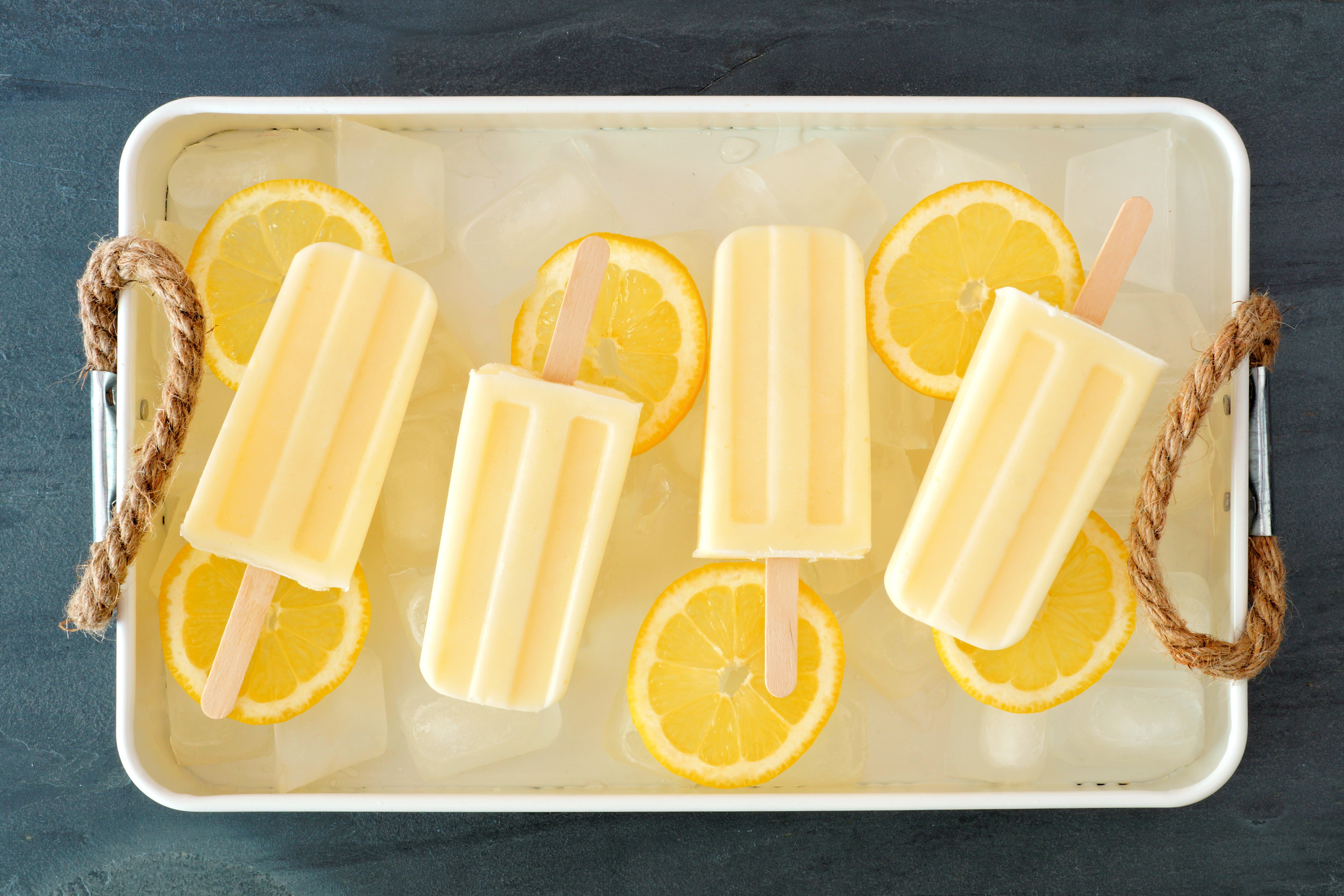 Lemon popsicles with lemon slices on ice HD Wallpaper