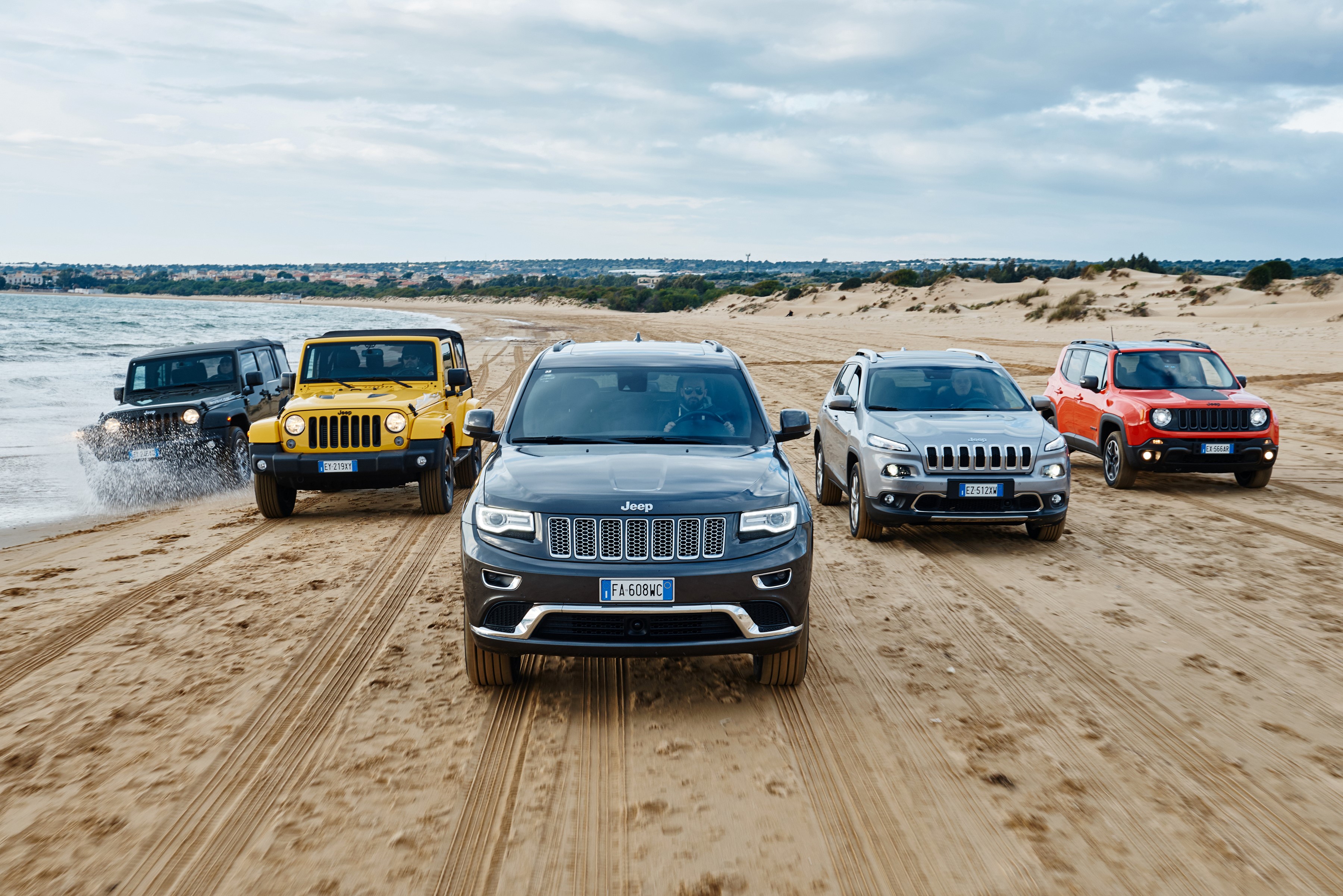 Jeep convoy driving on a sandy beach HD Wallpaper