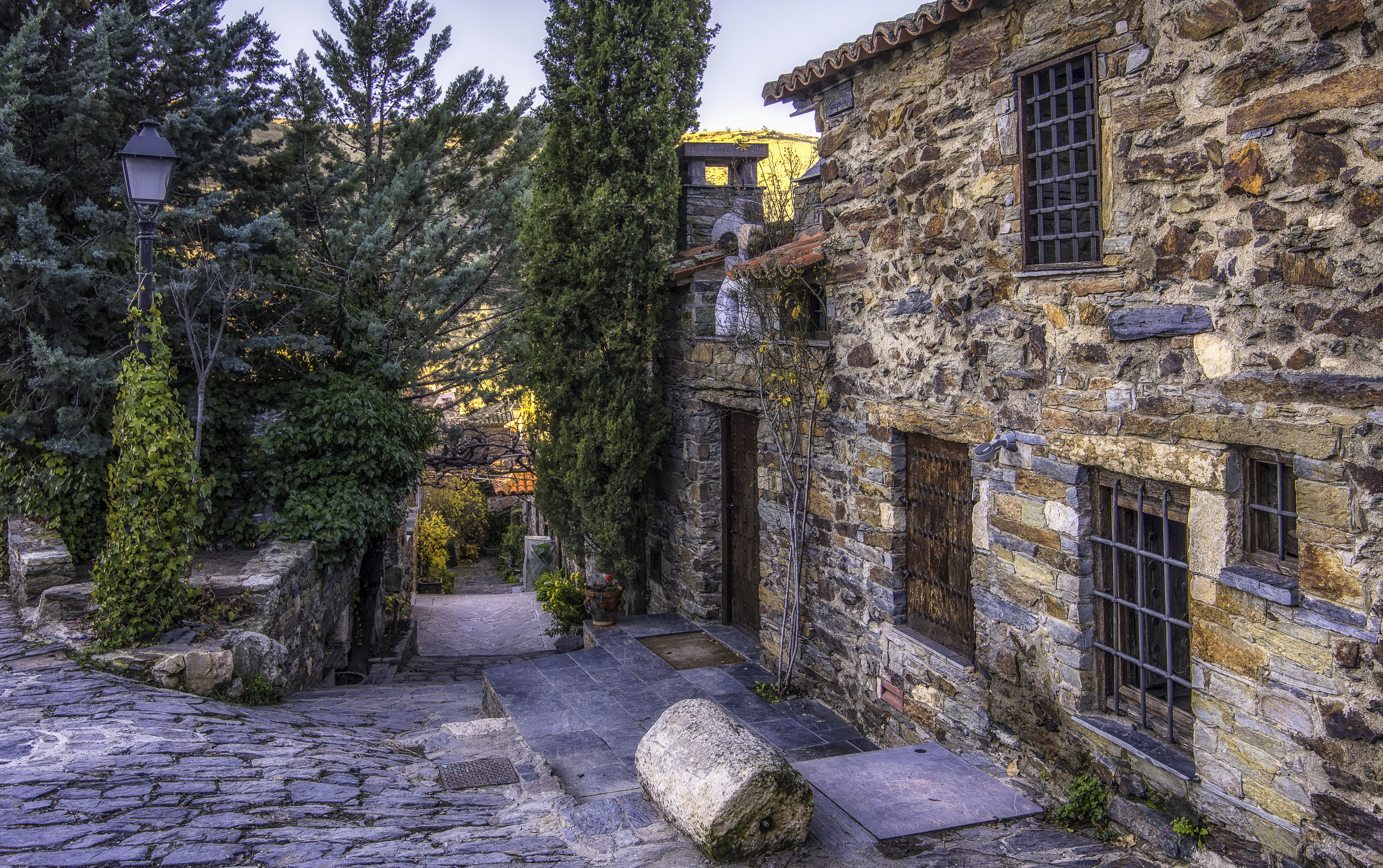 Stone houses on a cobblestone street in Madrid, Spain HD Wallpaper