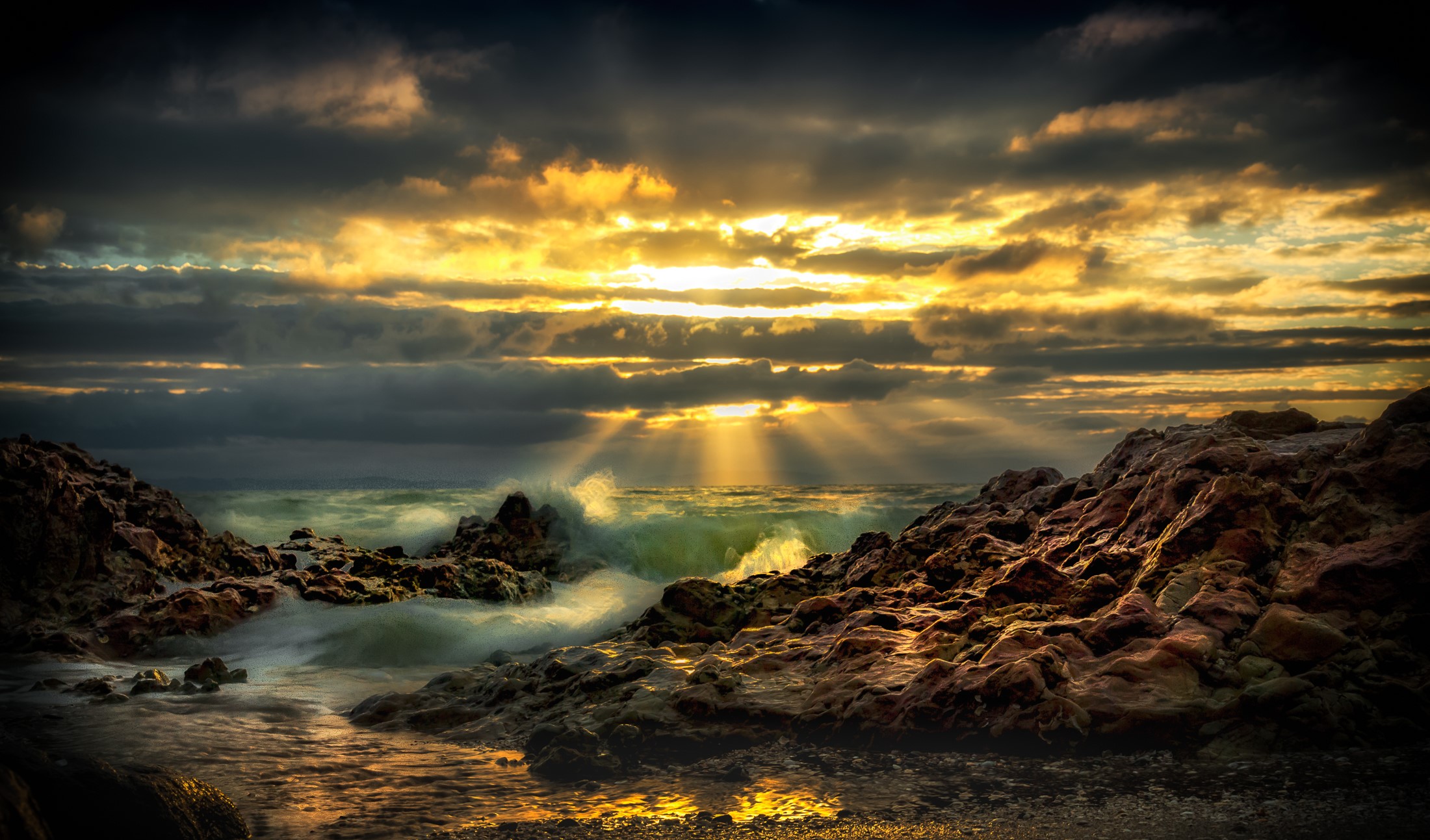Sunset over rocky coast with waves in Takaka, New Zealand HD Wallpaper