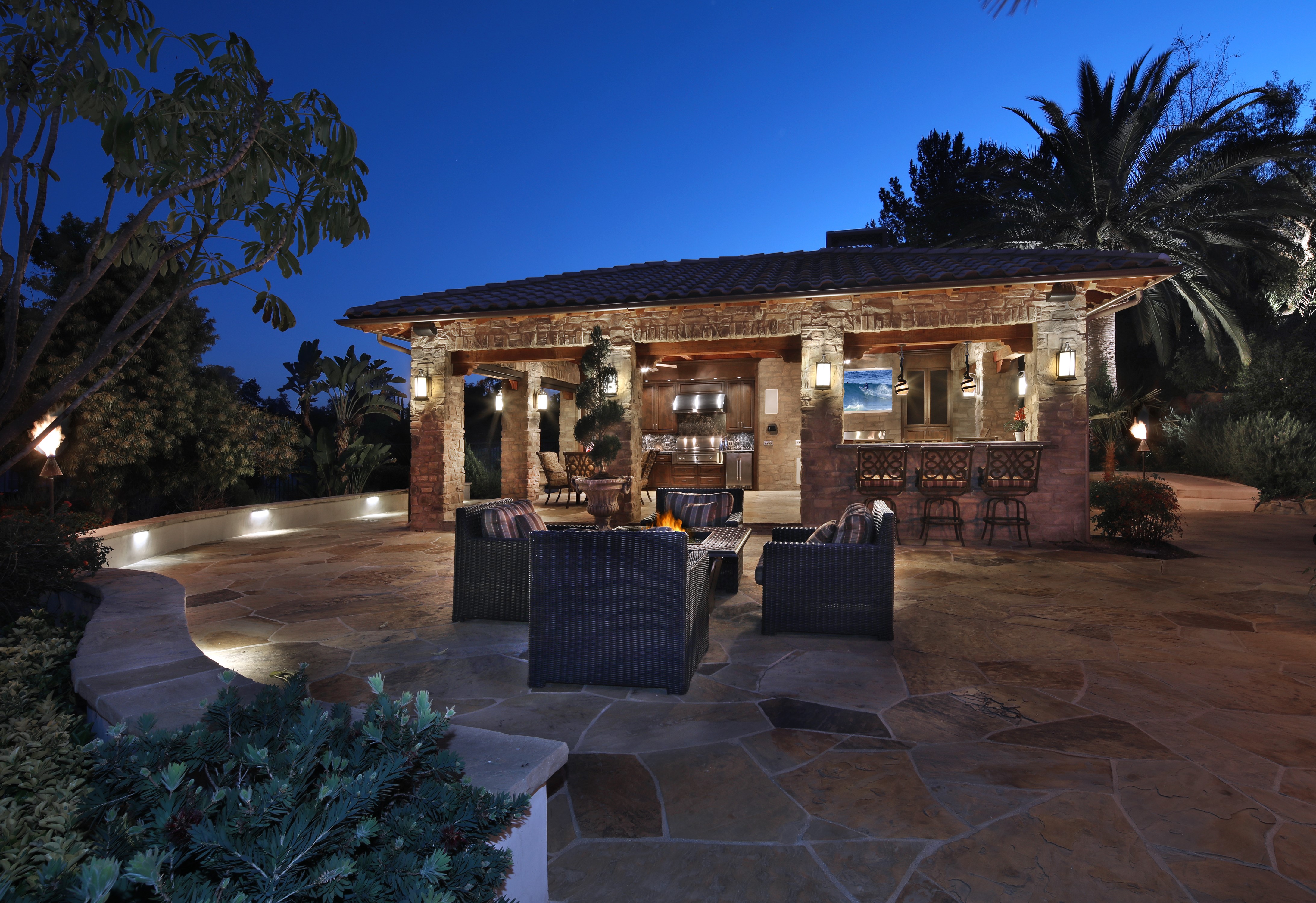 Outdoor kitchen and bar area at night HD Wallpaper
