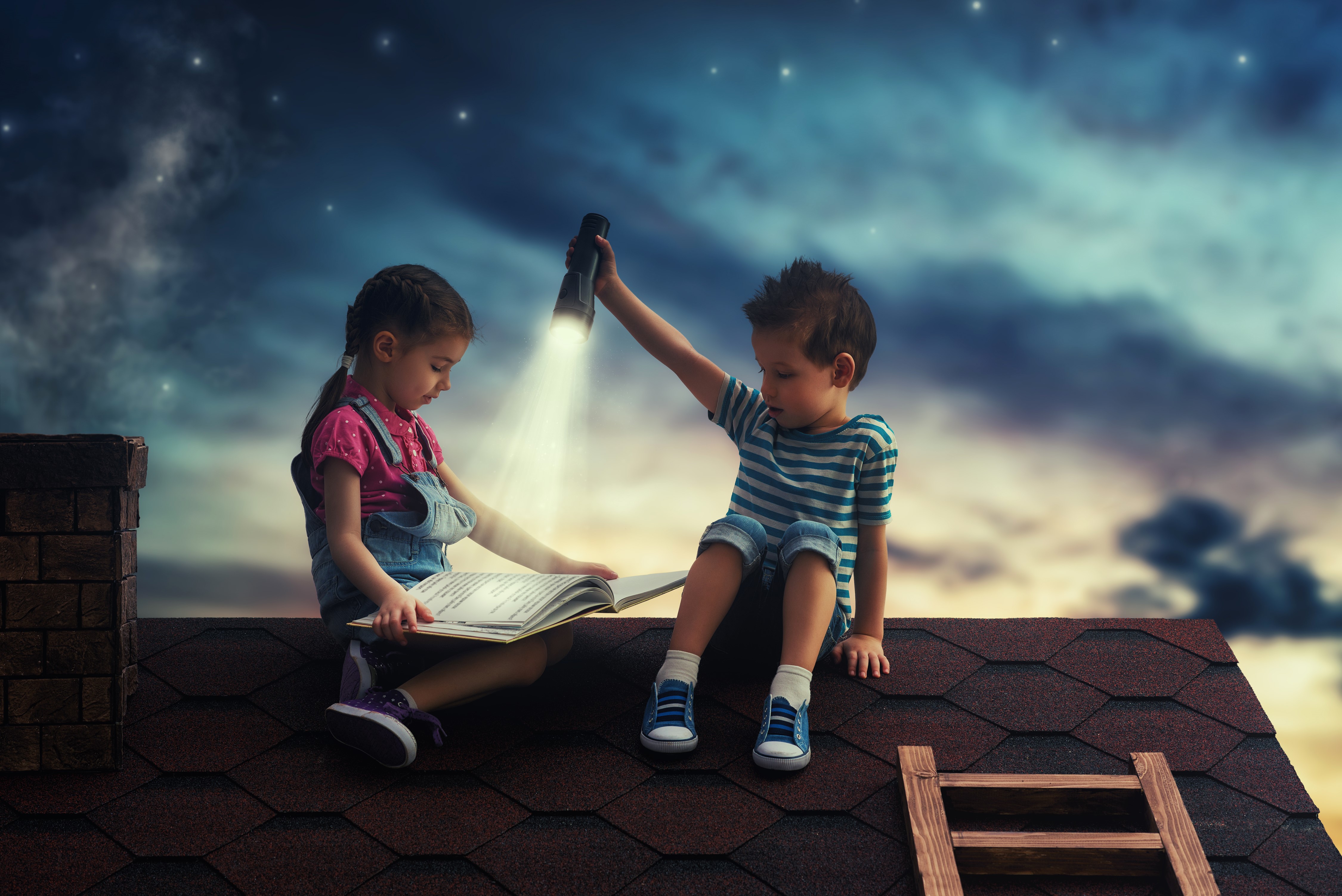 Children reading a book on a roof at night HD Wallpaper