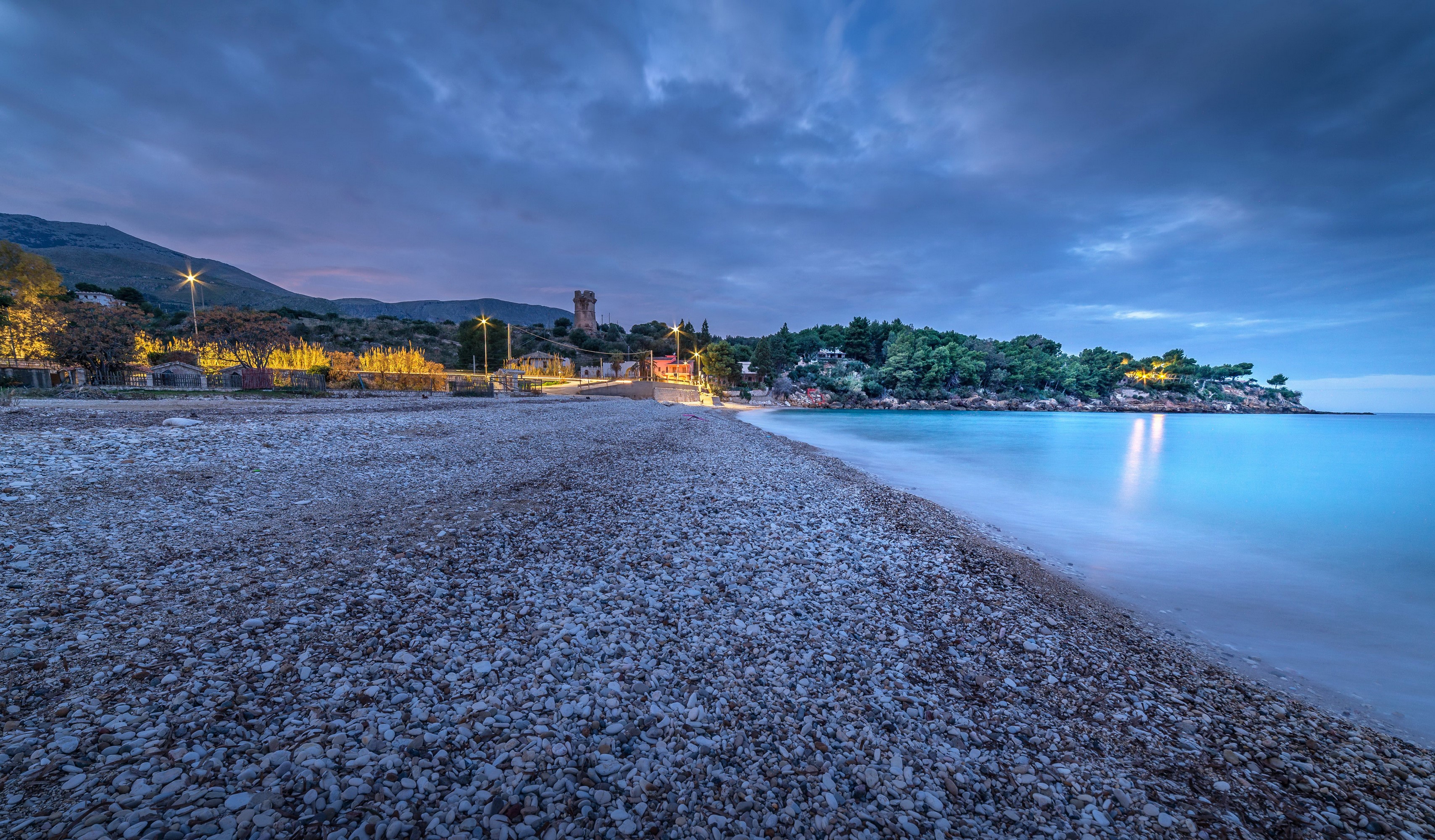 Pebble beach and calm sea at dusk in Sicily, Italy HD Wallpaper
