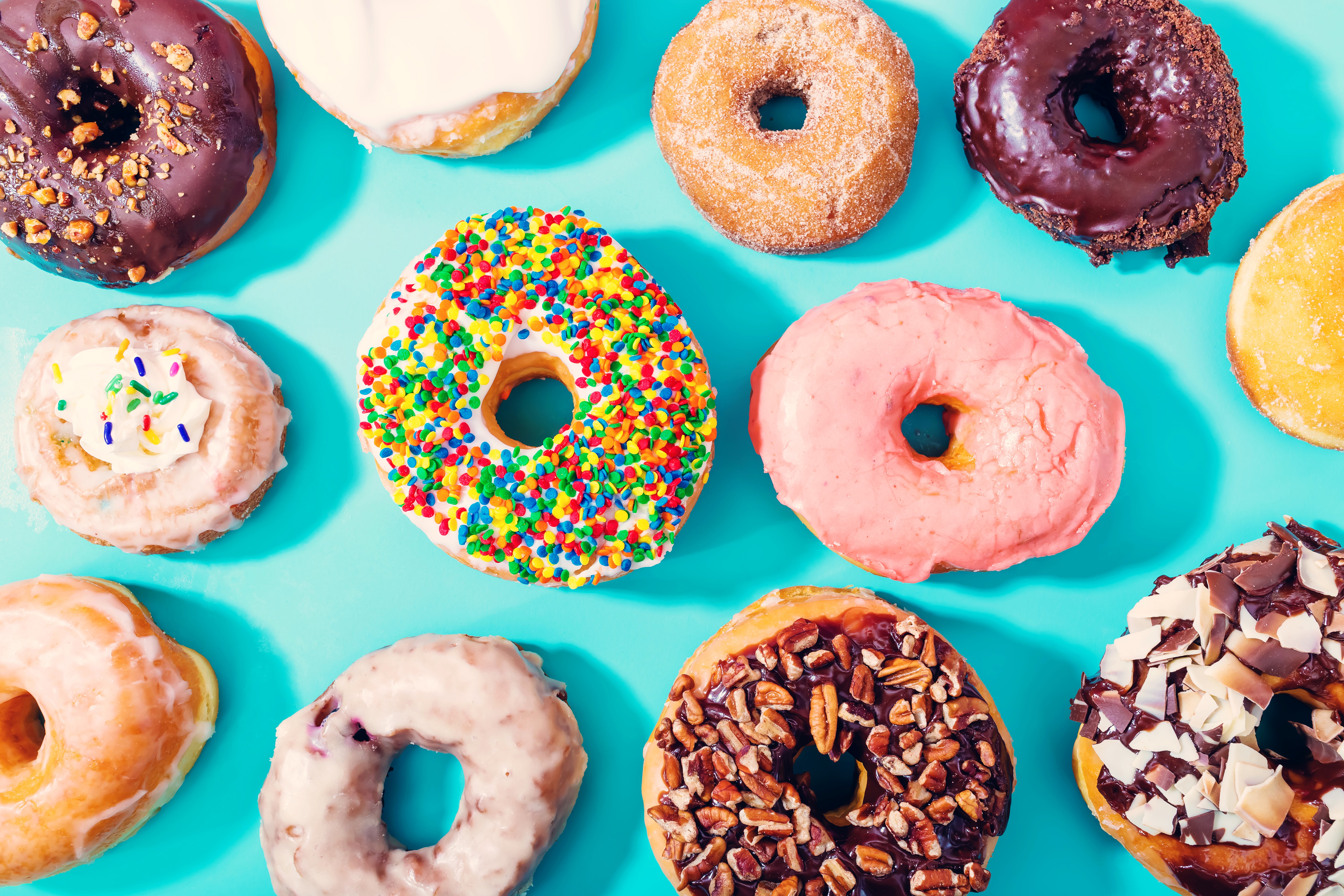 Assortment of donuts on a blue background HD Wallpaper