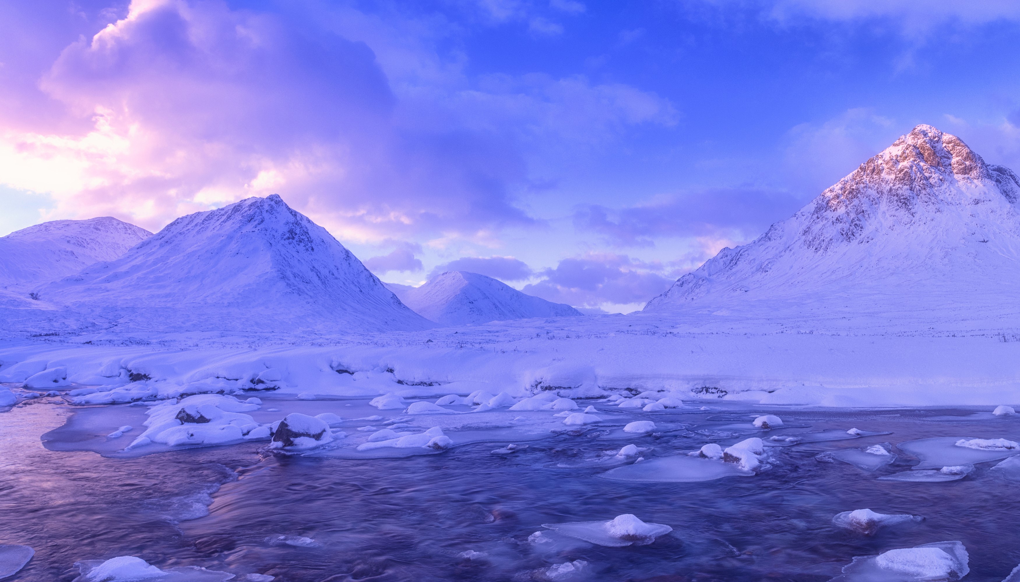 Snowy mountains and stream in Glen Coe, Scotland during winter HD Wallpaper