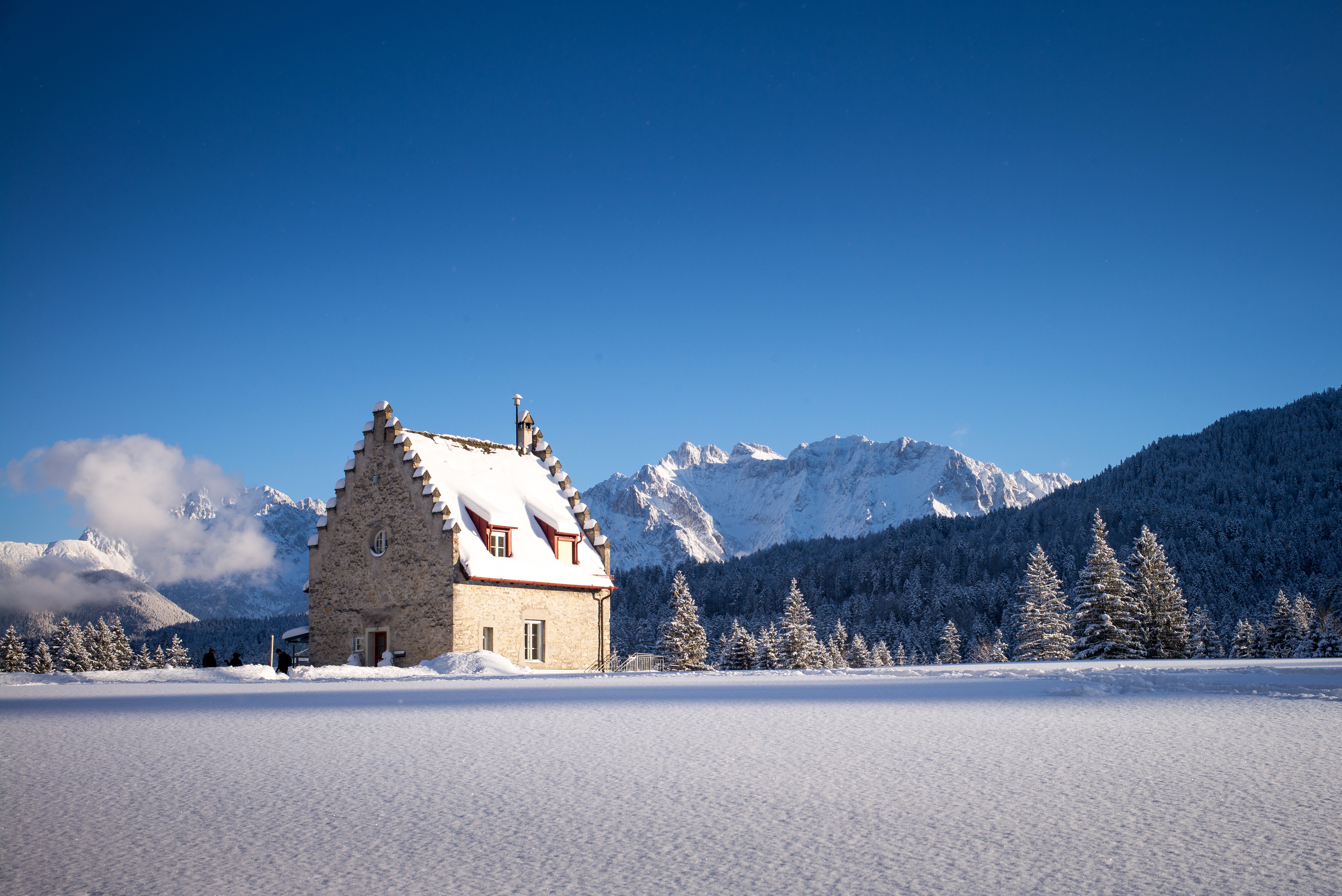 House in snowy Bavaria with mountains HD Wallpaper