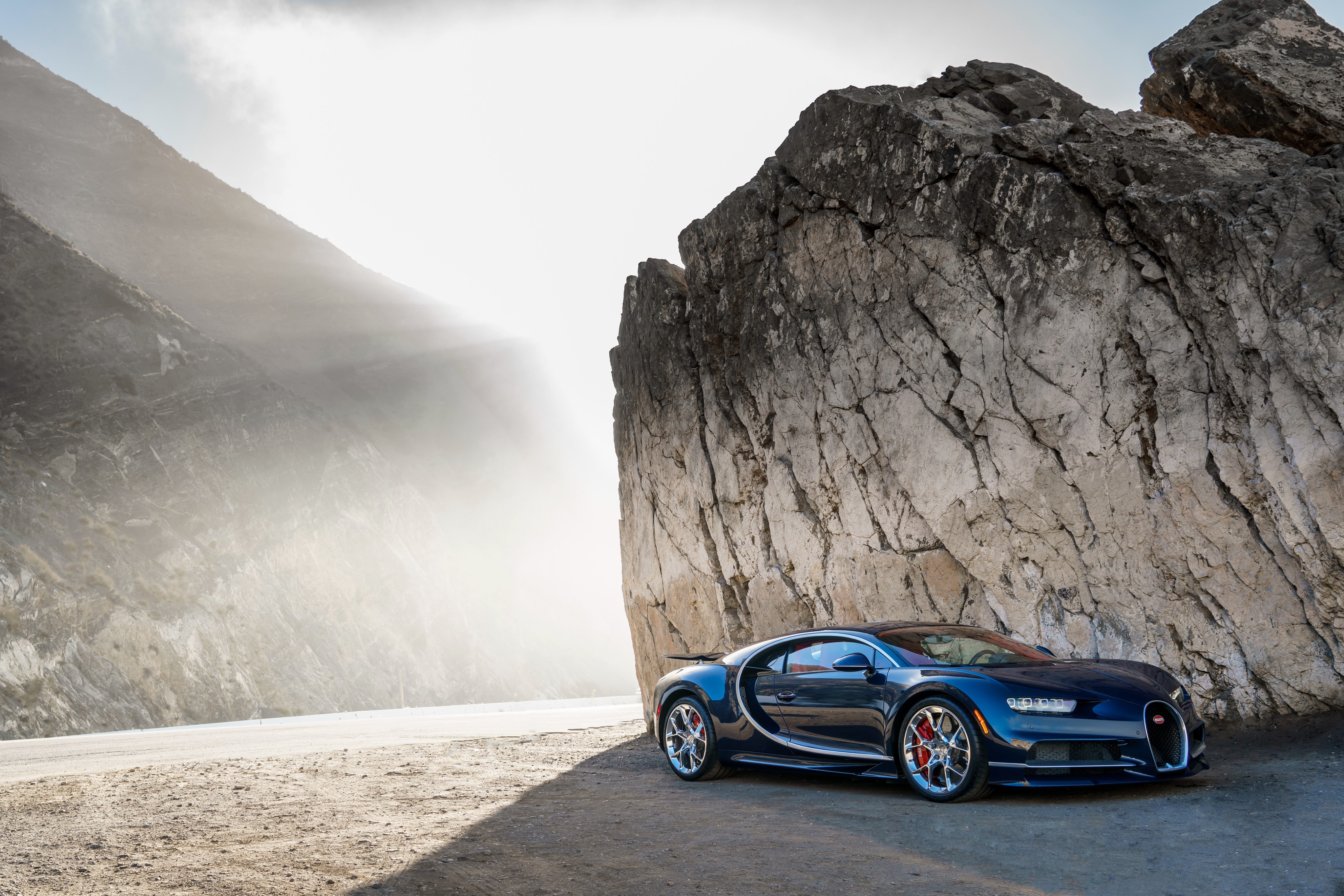 4K Bugatti Chiron parked by a rock formation HD Wallpaper