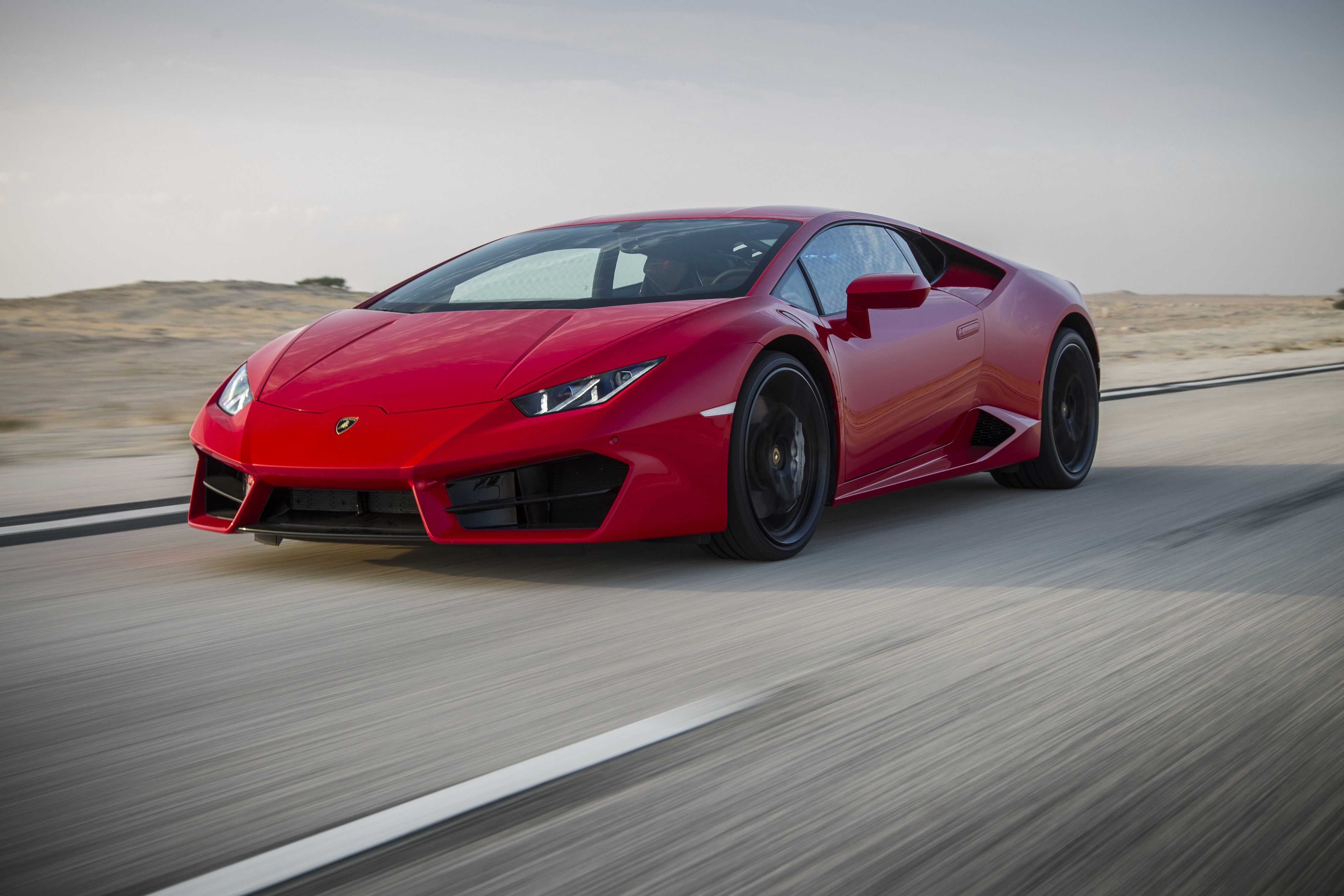 Red Lamborghini LP 580-2 Huracan in motion HD Wallpaper