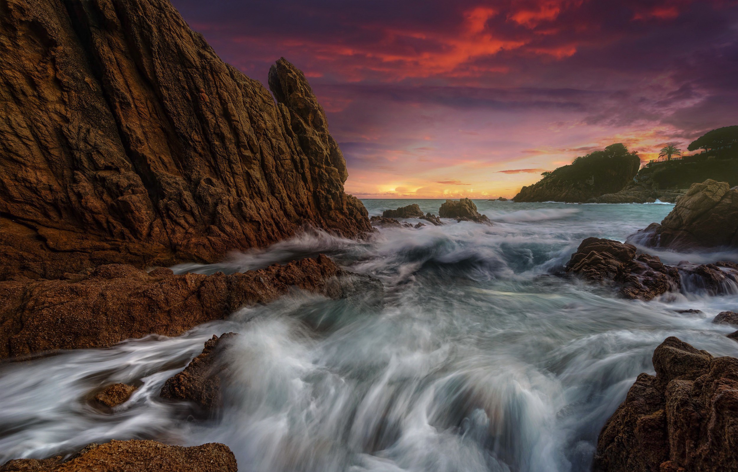 Sunset over rocky coast with waves in Catalonia, Spain HD Wallpaper