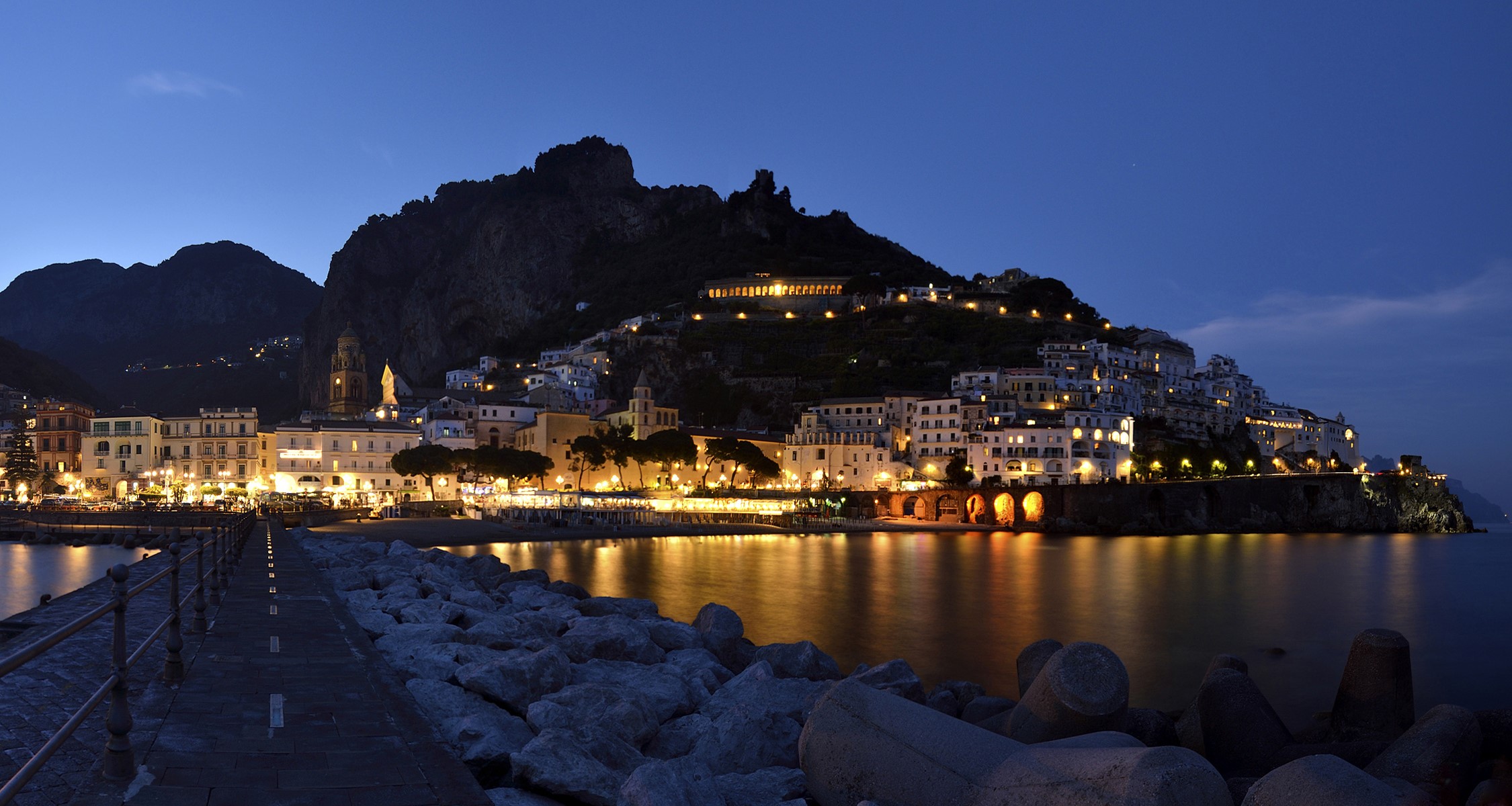Amalfi, Italy at dusk with illuminated buildings and sea HD Wallpaper
