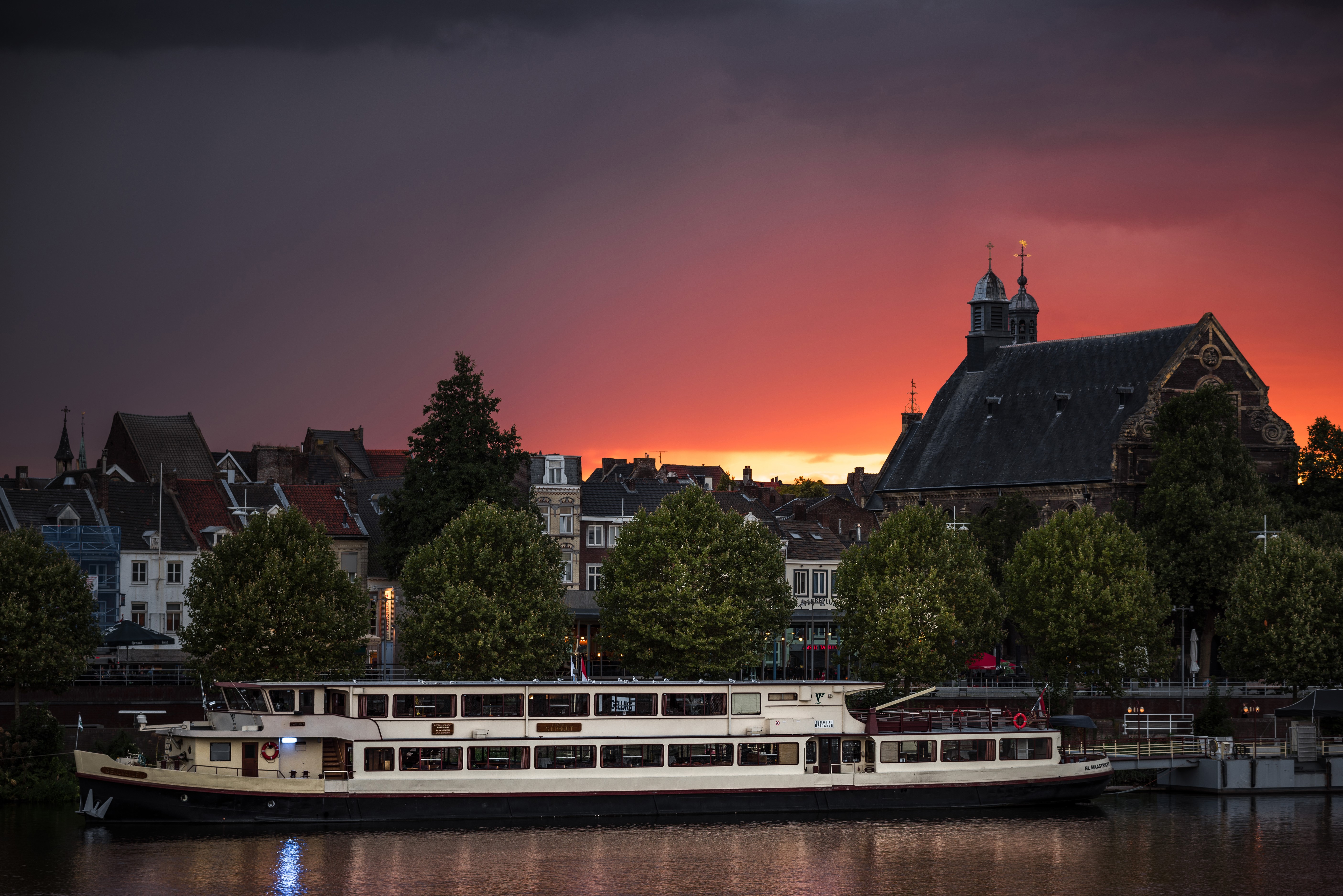 Riverboat docked in Maastricht at sunset HD Wallpaper