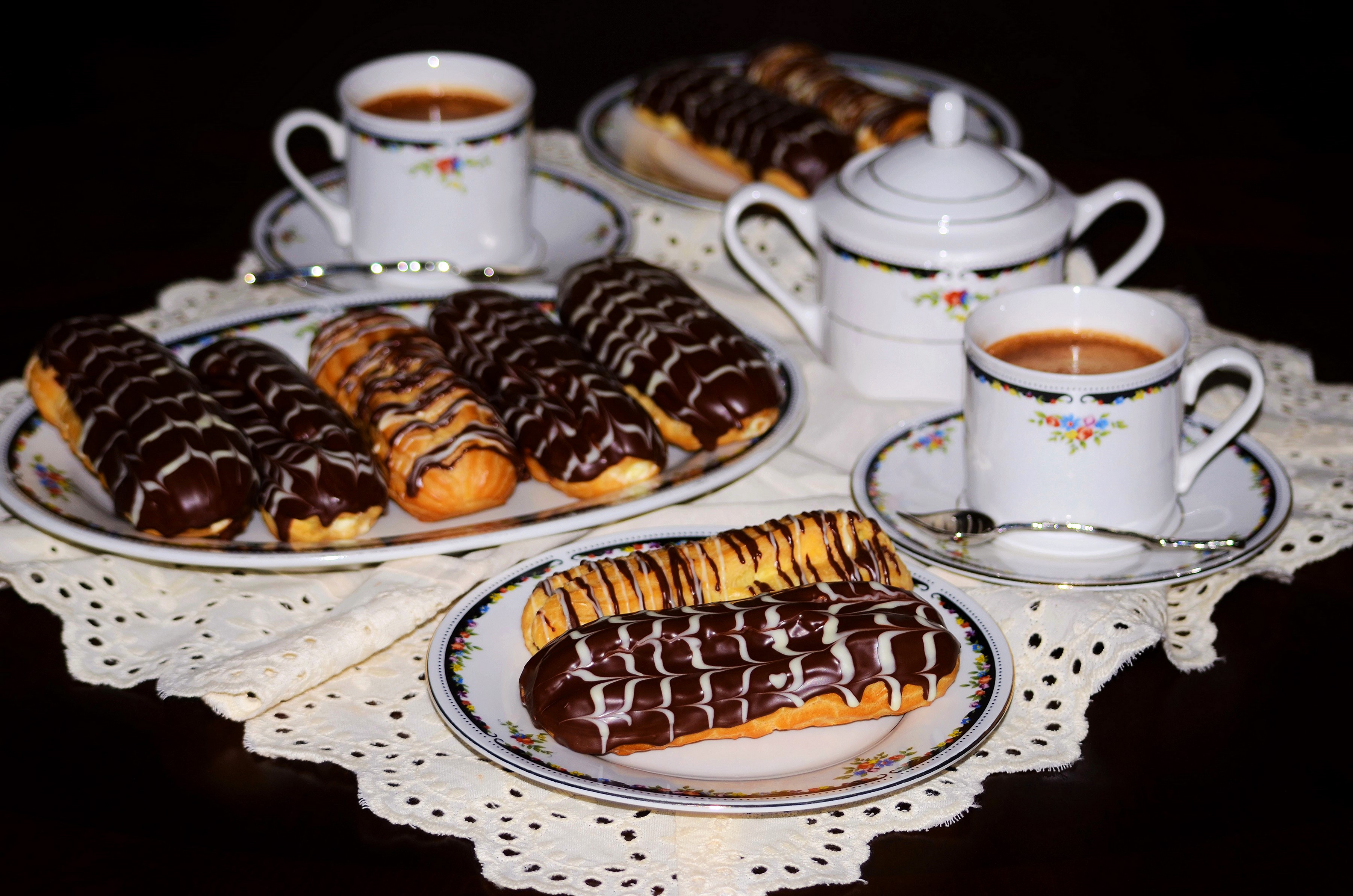 Eclairs and coffee on a table HD Wallpaper