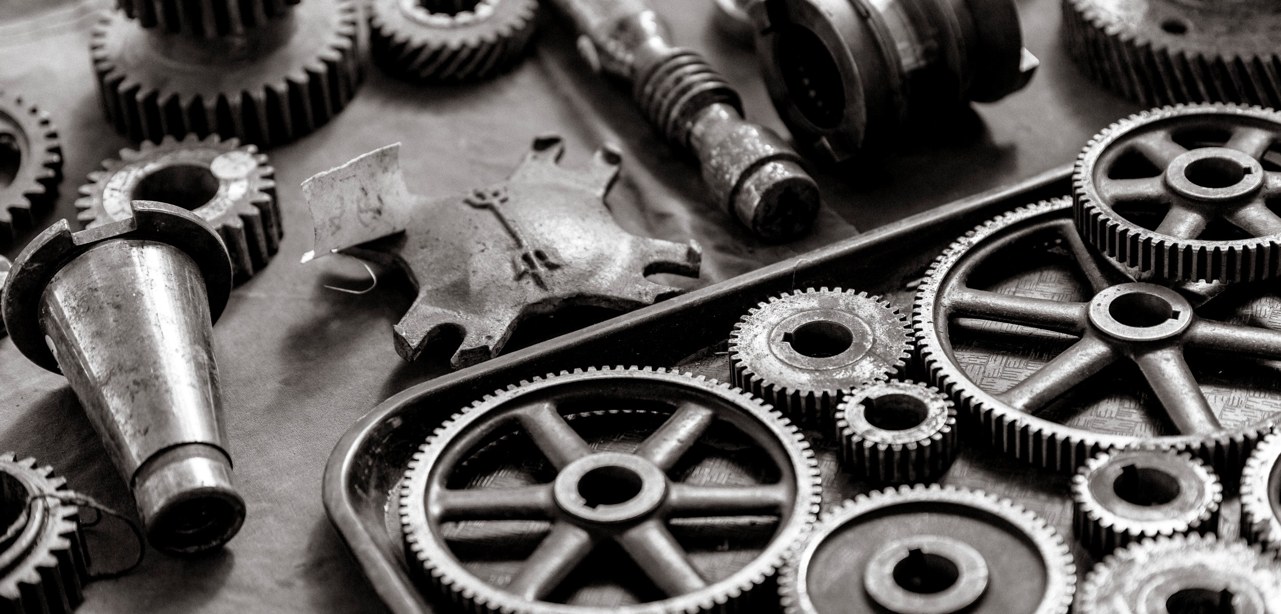 Close-up of various metal gears and mechanical parts HD Wallpaper