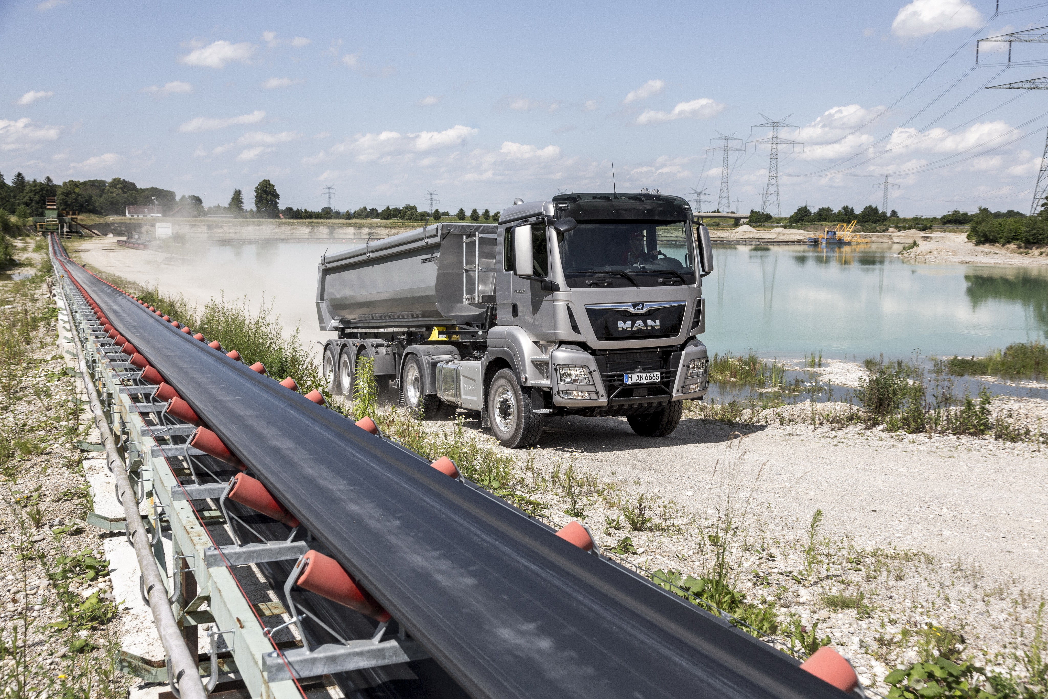MAN SE dump truck at a quarry with conveyor belt HD Wallpaper