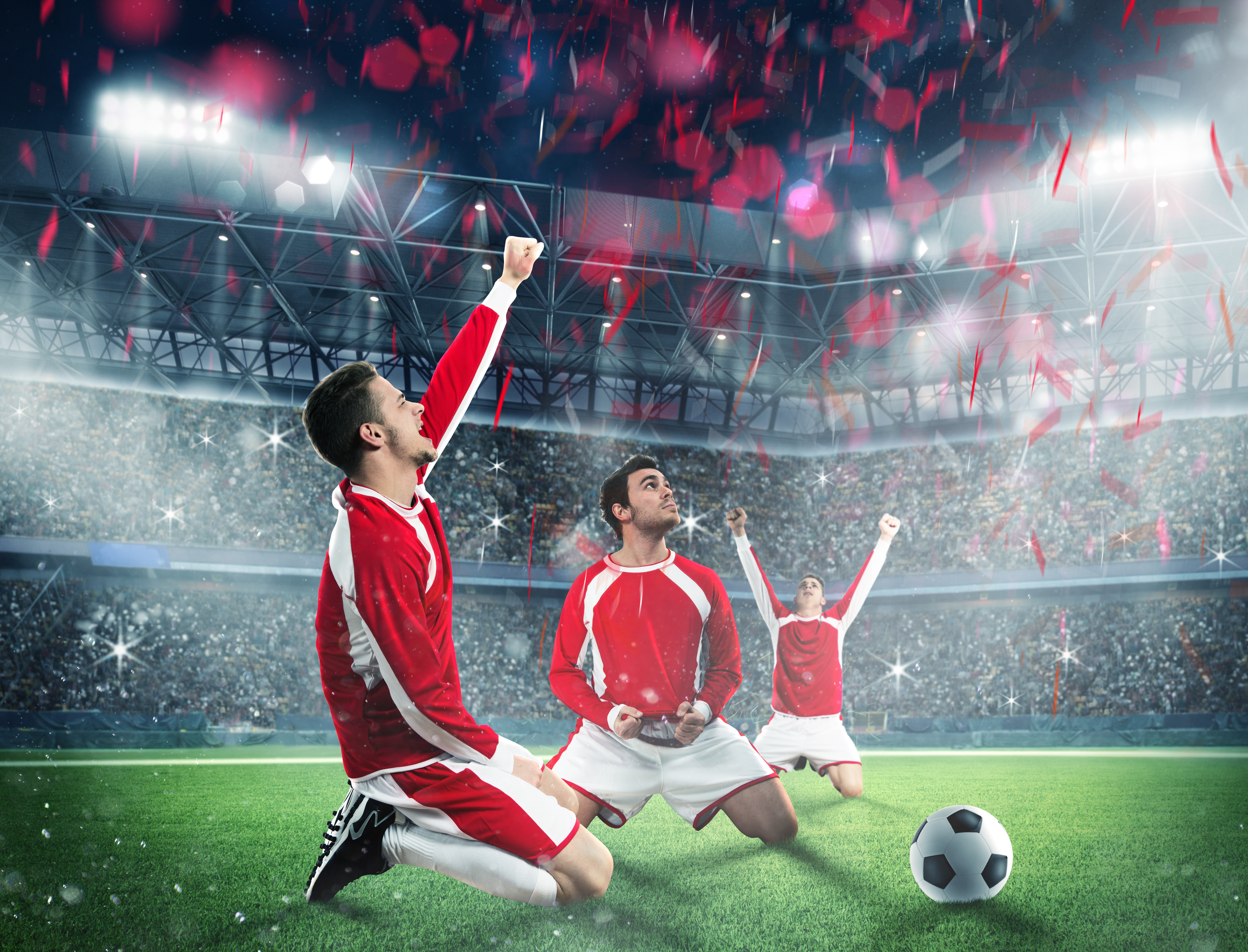 Three men in soccer uniforms celebrating on a field HD Wallpaper