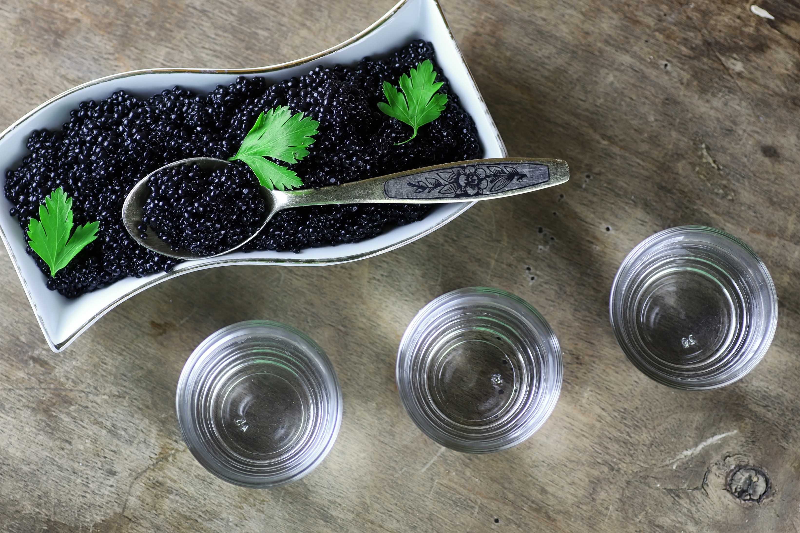 Black caviar with vodka and parsley on wood HD Wallpaper