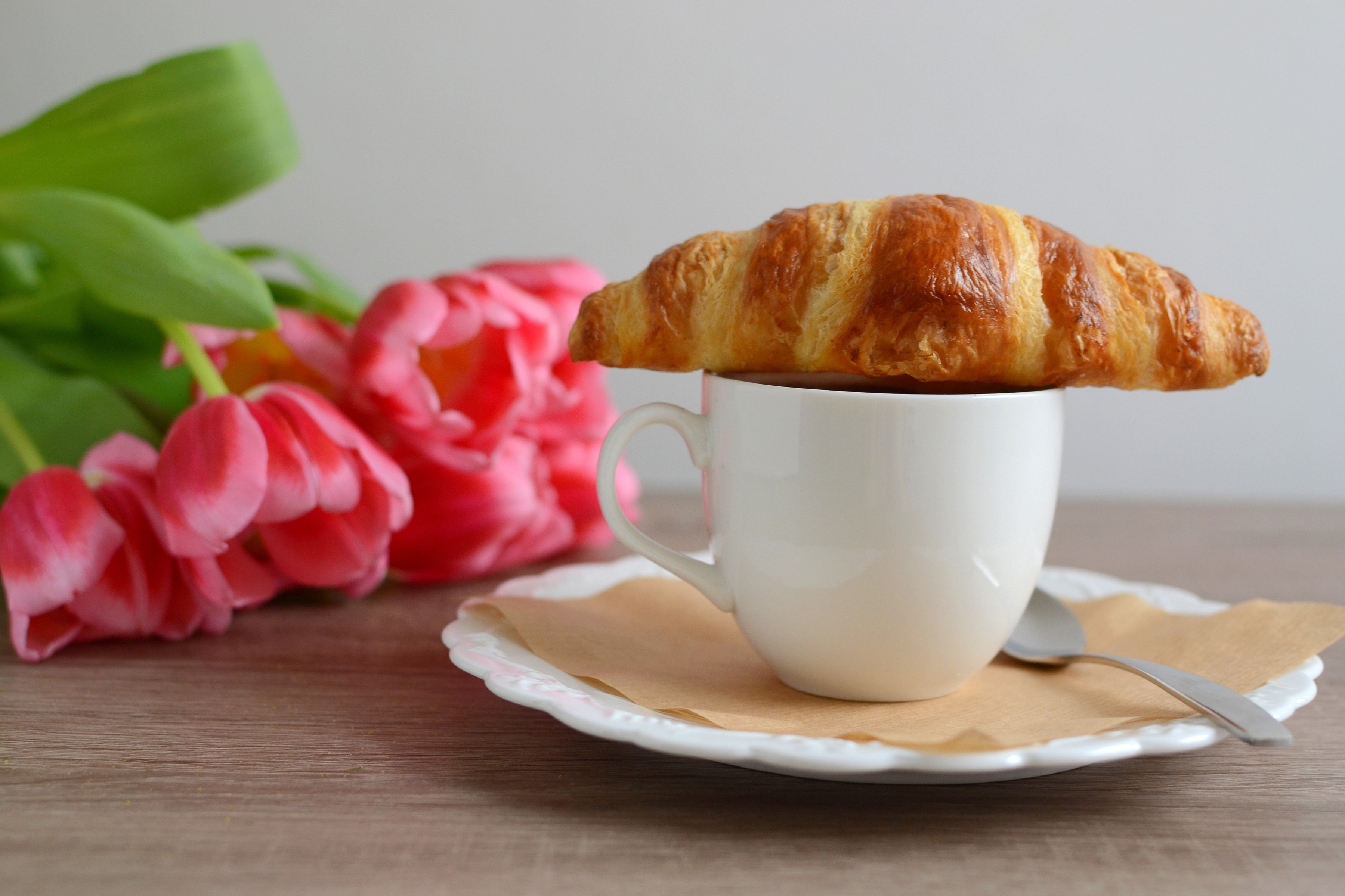Croissant on a cup with tulips HD Wallpaper