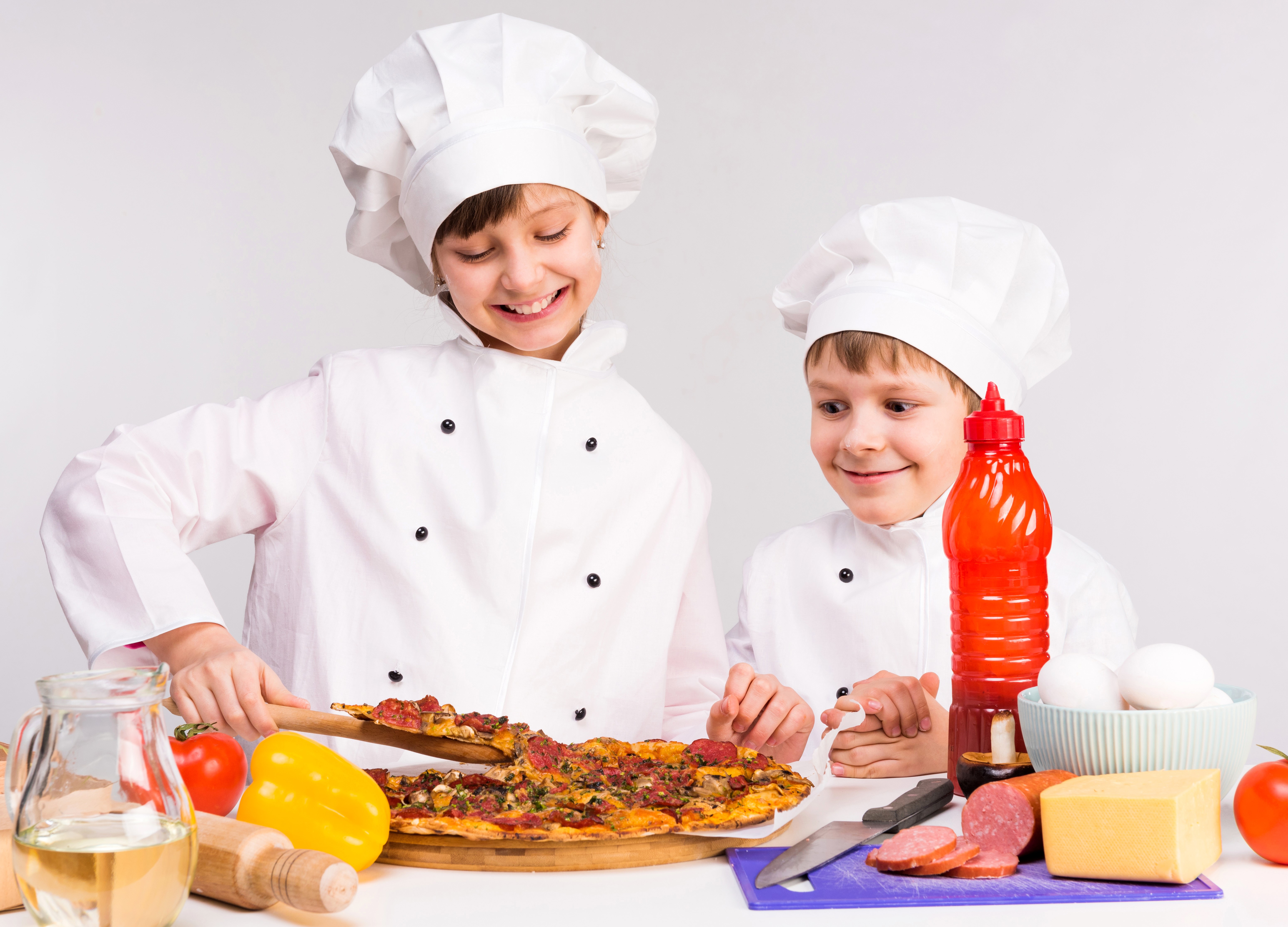 Two young chefs preparing pizza HD Wallpaper