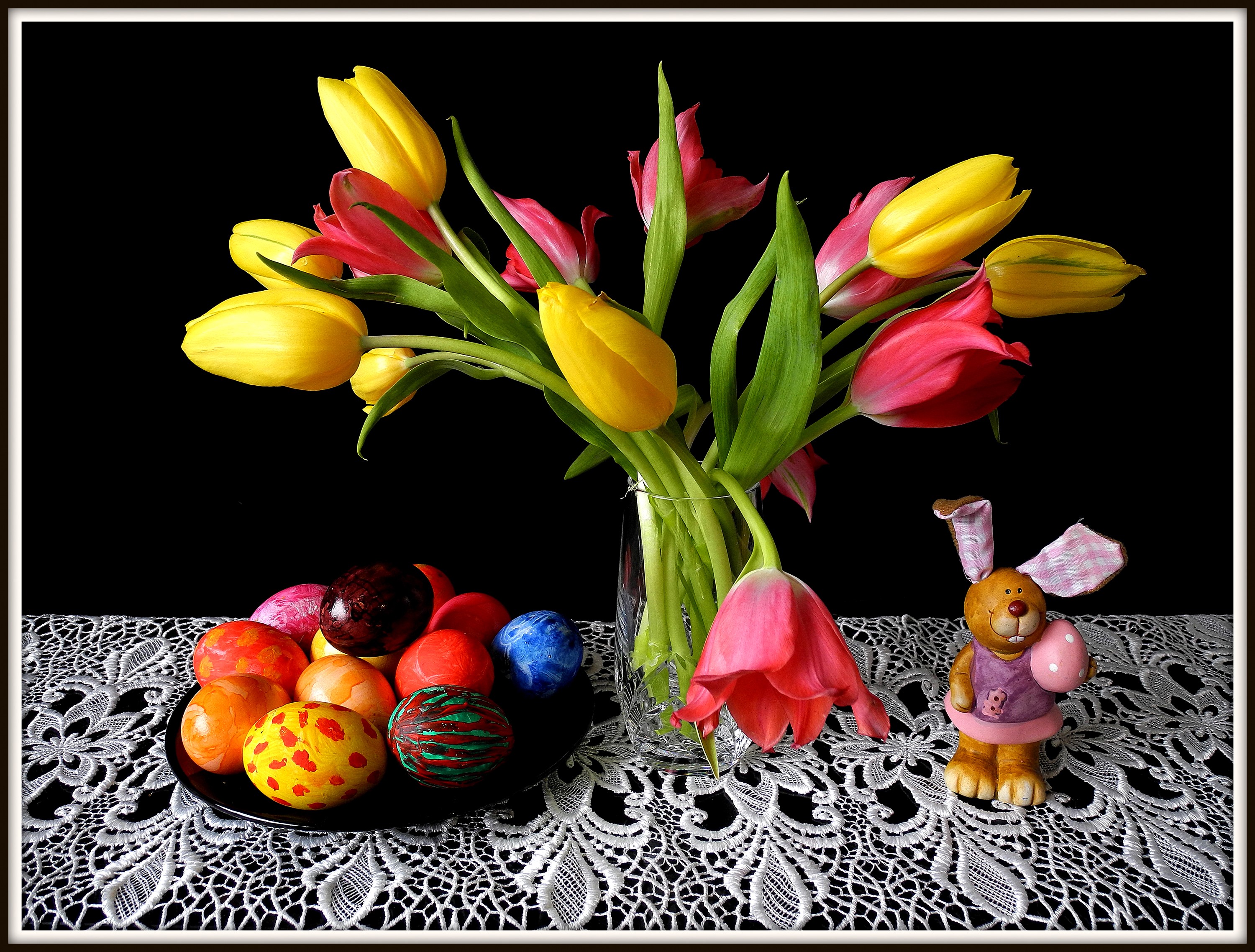 Easter still life with tulips, painted eggs, and a bunny figurine HD Wallpaper
