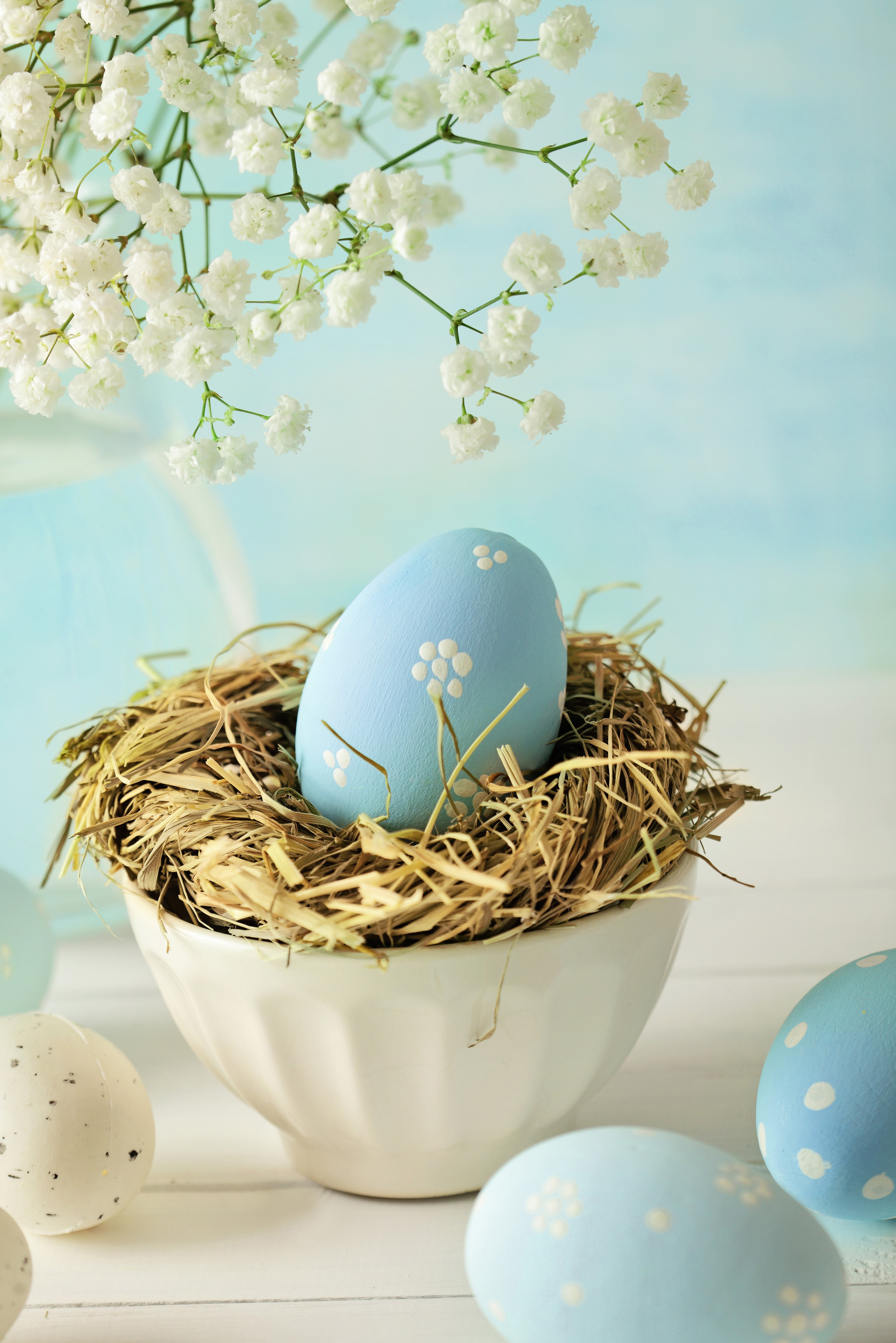 Easter eggs in a nest with flowers HD Phone Wallpaper