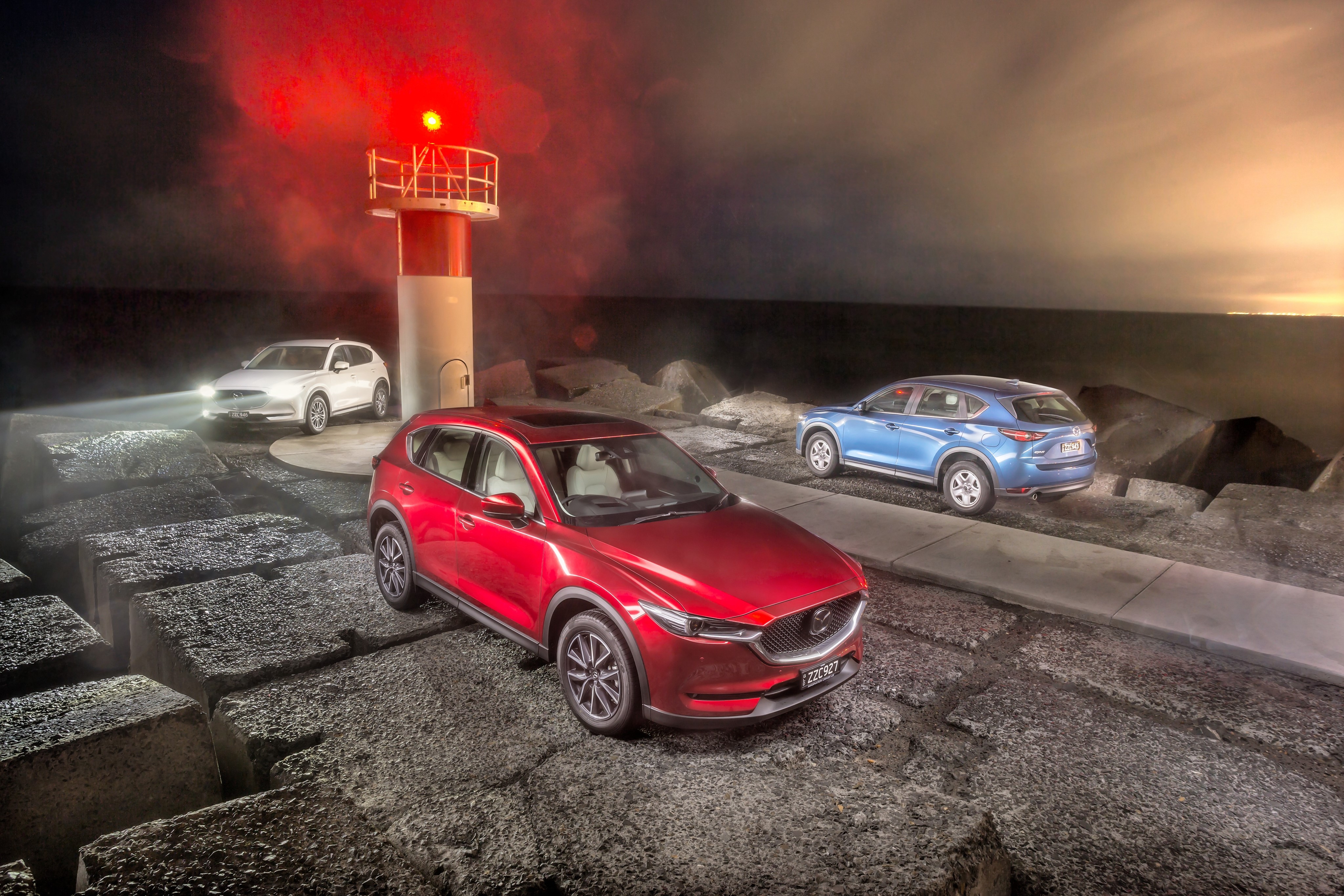 Three Mazda CX-5s at a Lighthouse HD Wallpaper