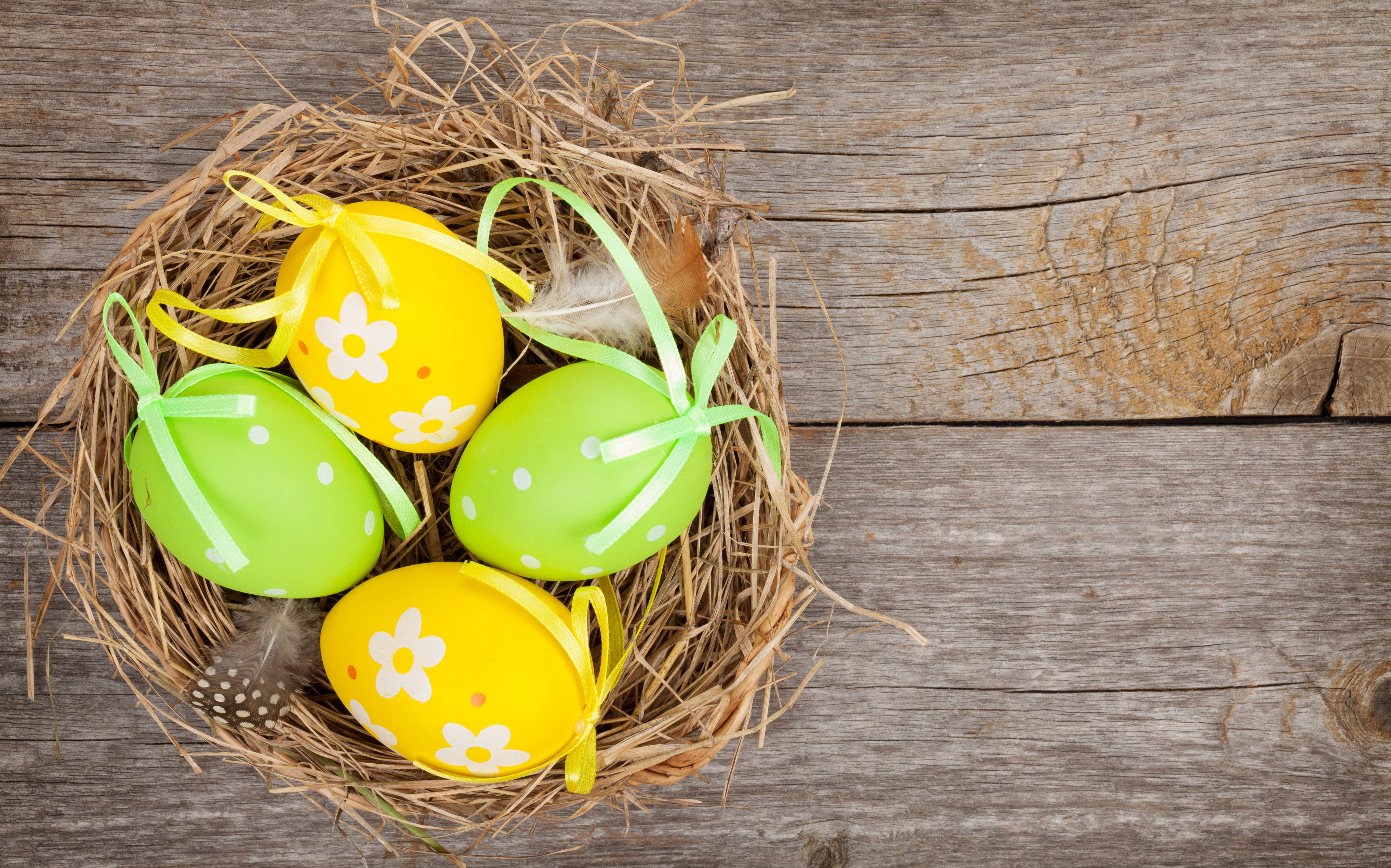 Easter eggs in a nest on wood planks HD Wallpaper