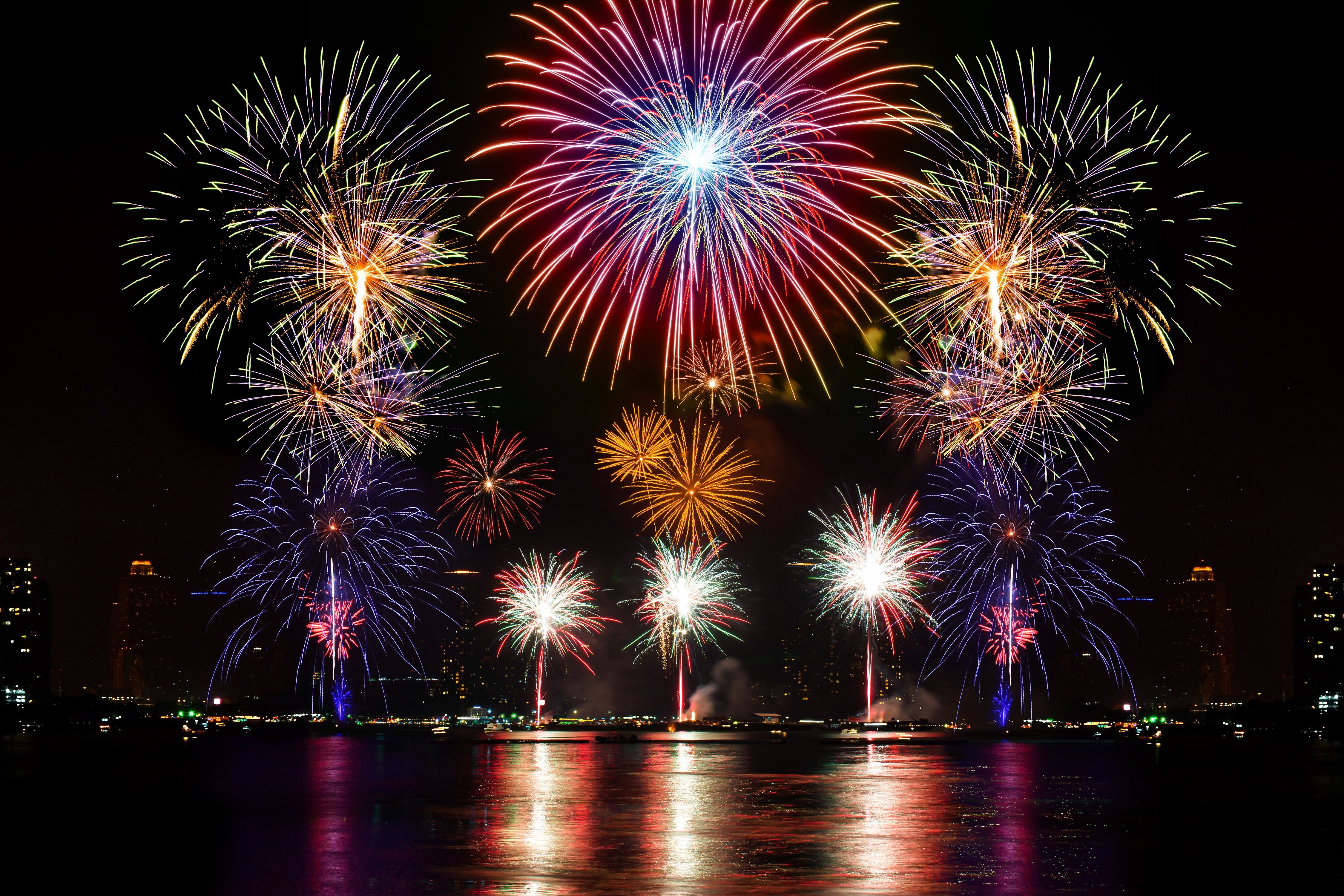 4K Fireworks Display Over City Skyline at Night HD Wallpaper