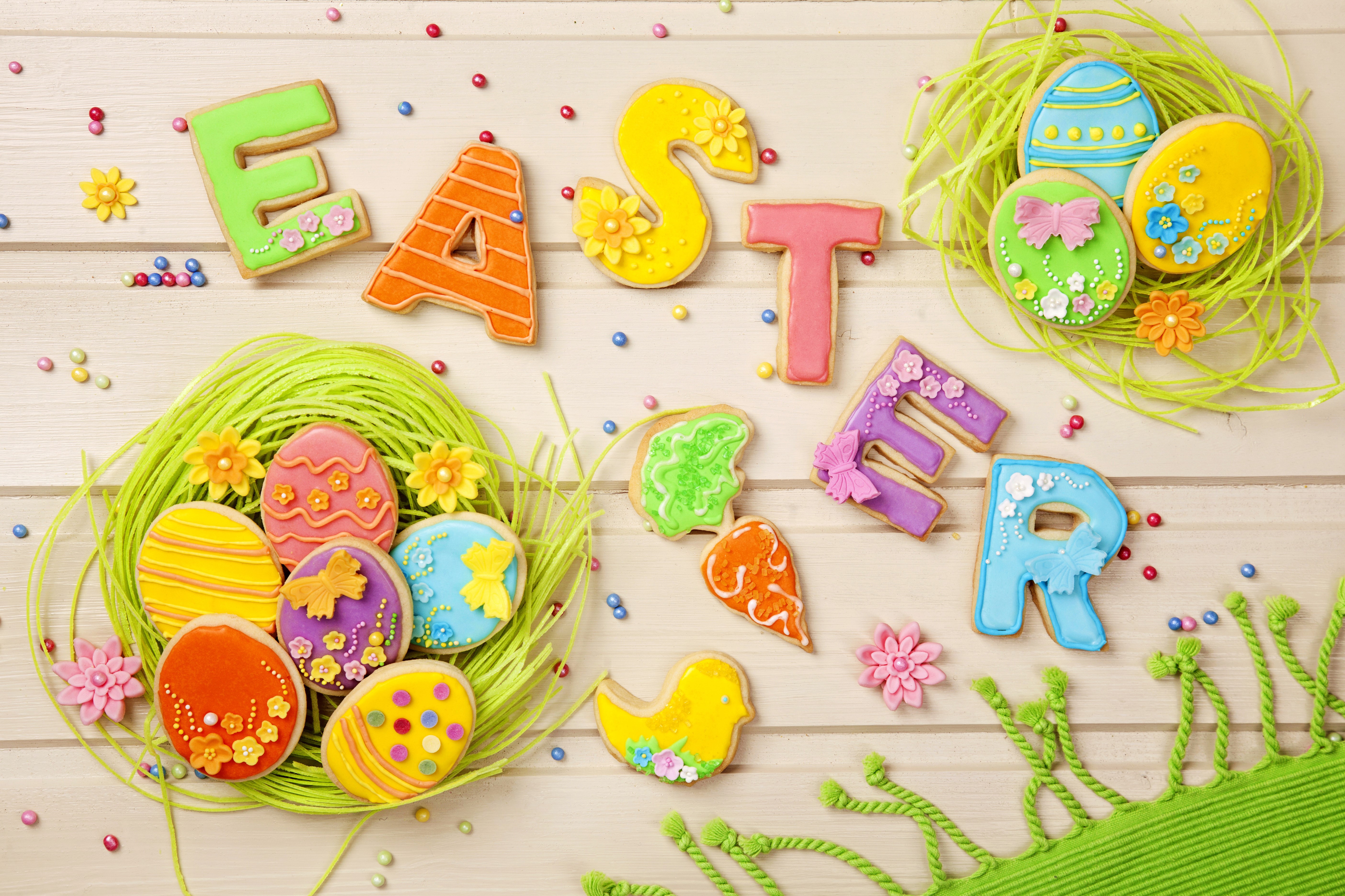 Easter cookies spelling out "EASTER" with decorated eggs in nests HD Wallpaper