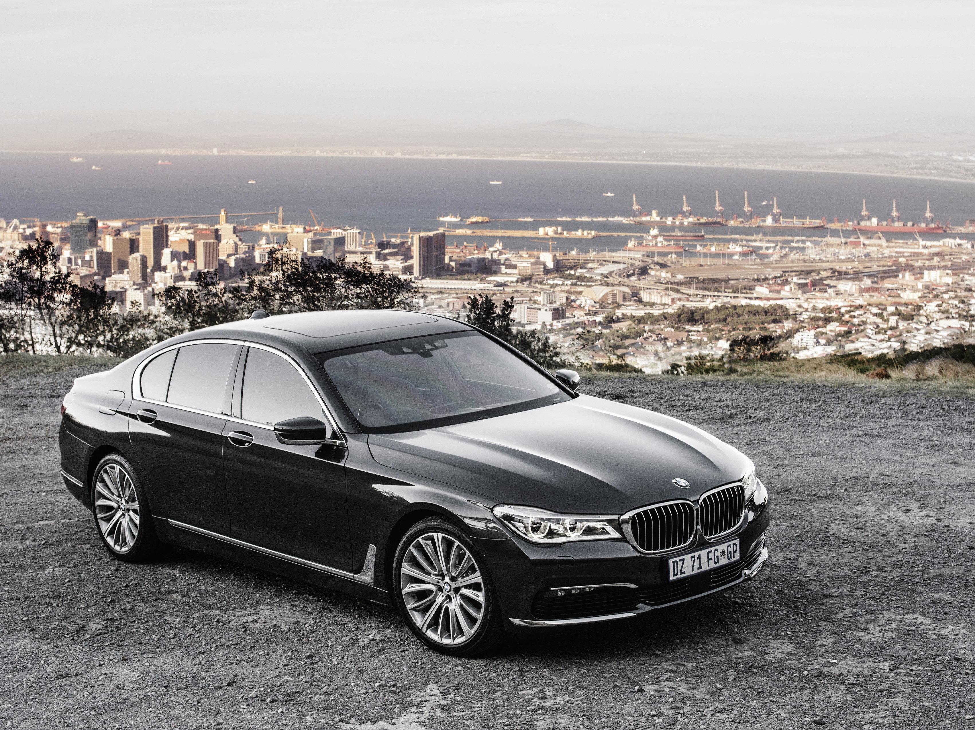 Black BMW 7-Series Sedan with Cityscape Background HD Wallpaper