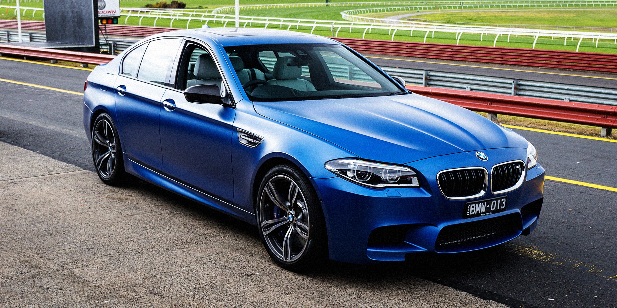 Blue BMW M5 F10 Sedan on a Racetrack HD Wallpaper