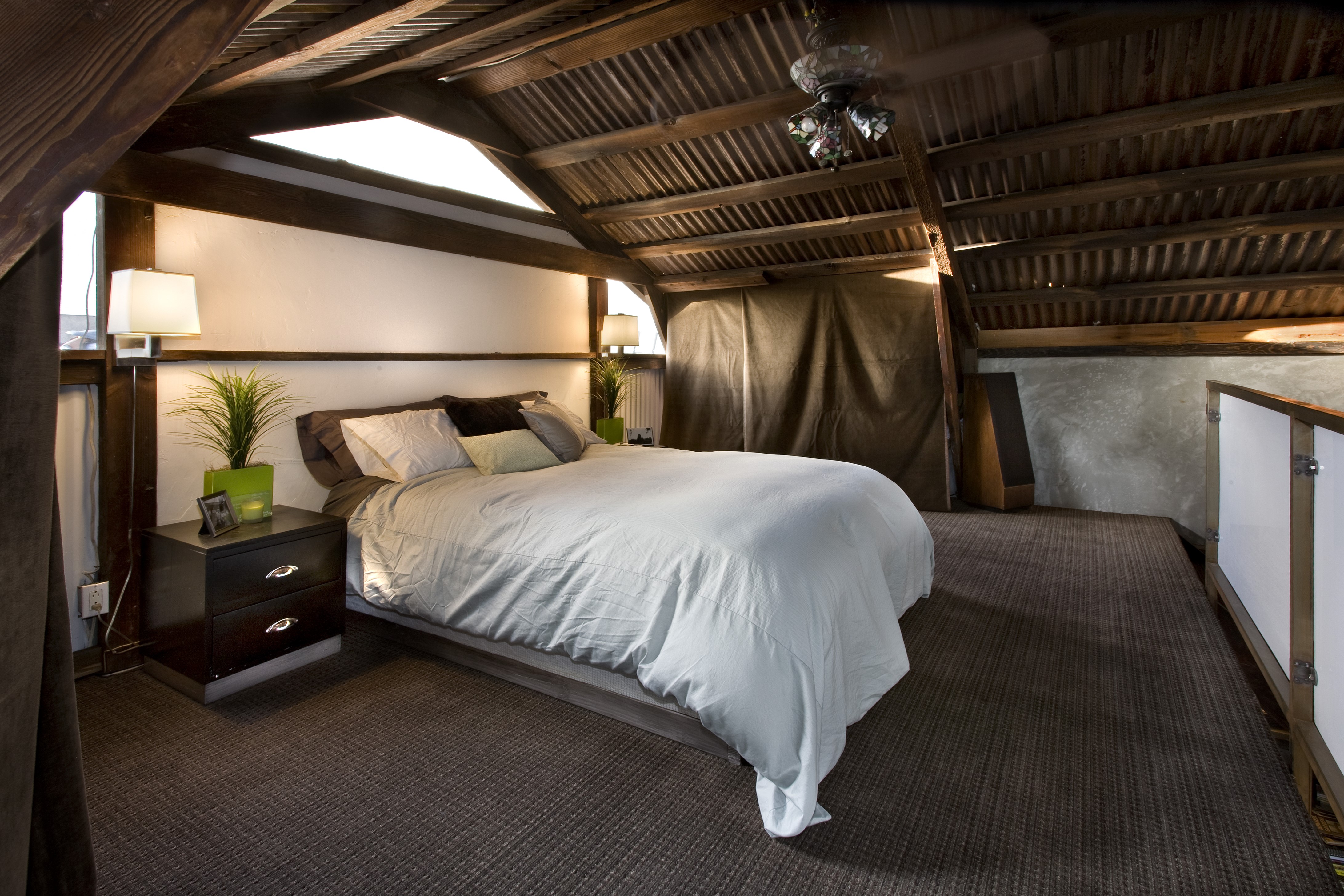 Bedroom with corrugated metal ceiling and wooden beams HD Wallpaper