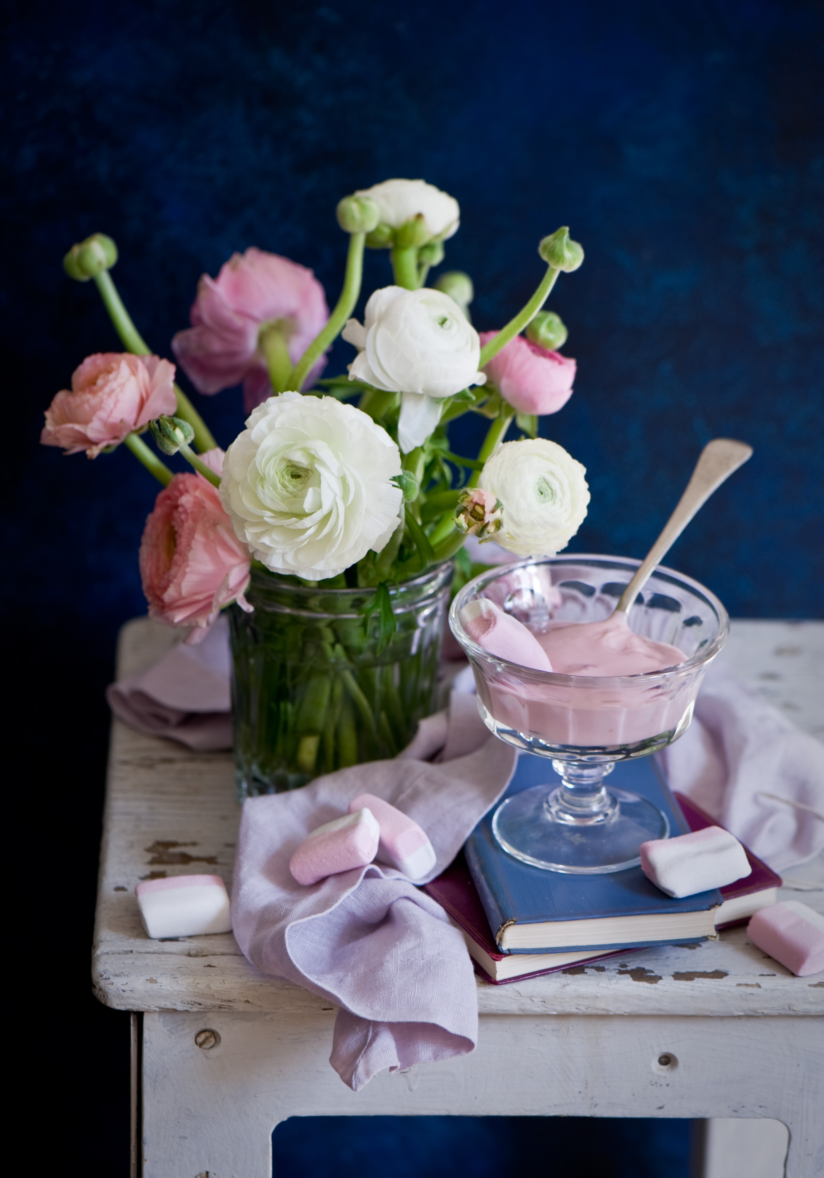 Still-life with Ranunculus flowers, sweets, and books HD Phone Wallpaper