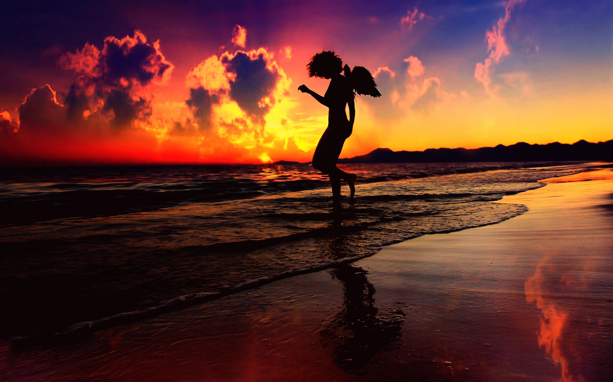 Silhouette of an angel on a beach at sunset HD Wallpaper