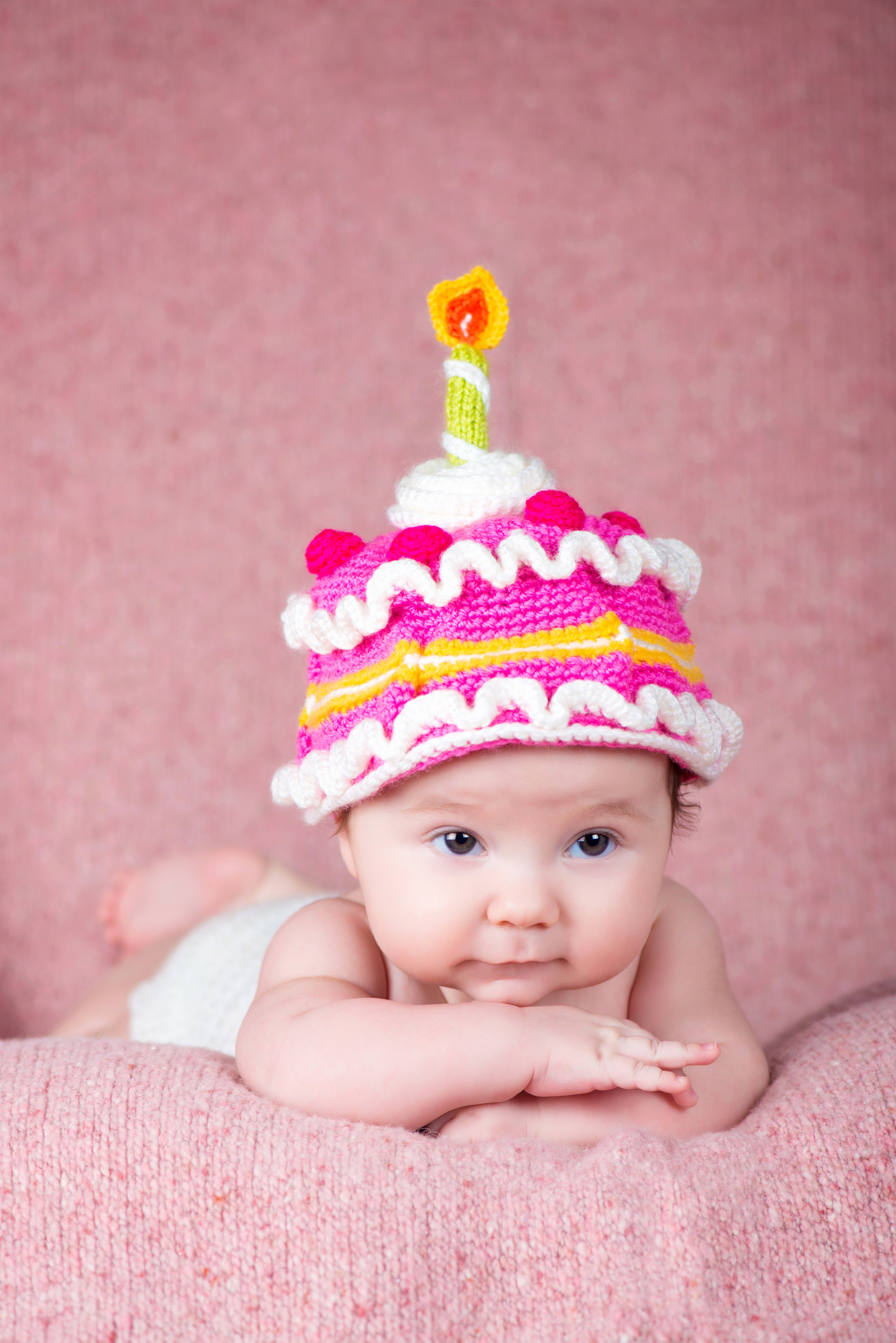 Baby wearing a cake hat with a candle HD Phone Wallpaper